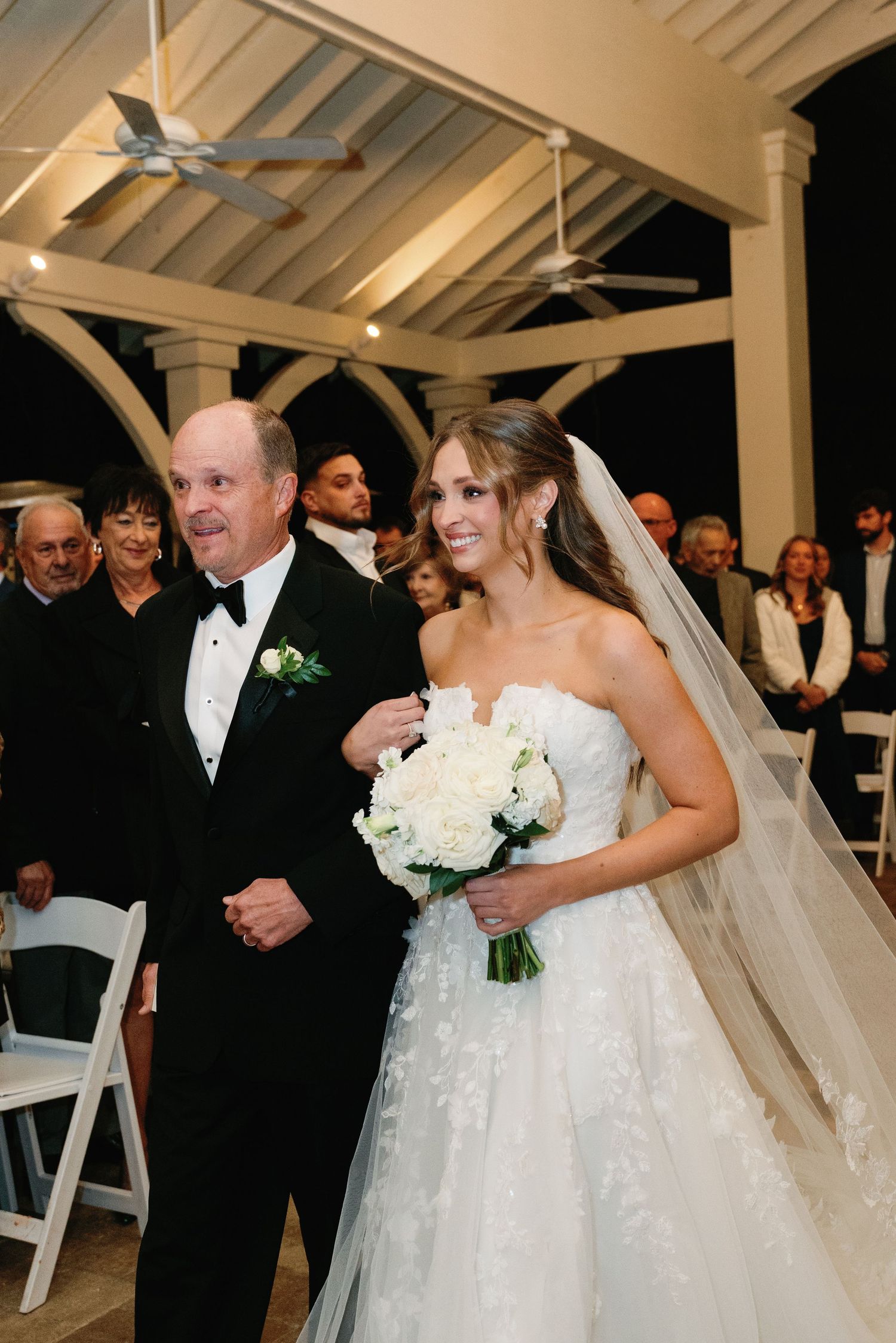 A sequence of candid wedding ceremony moments showing joyful interactions in an indoor venue with white chairs.