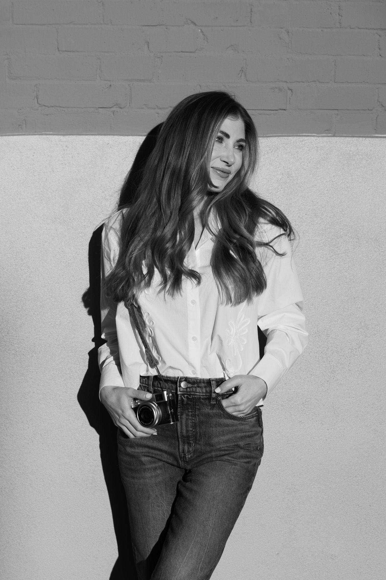 Black and white fashion photo series showing casual style with white shirt and dark jeans against light background.