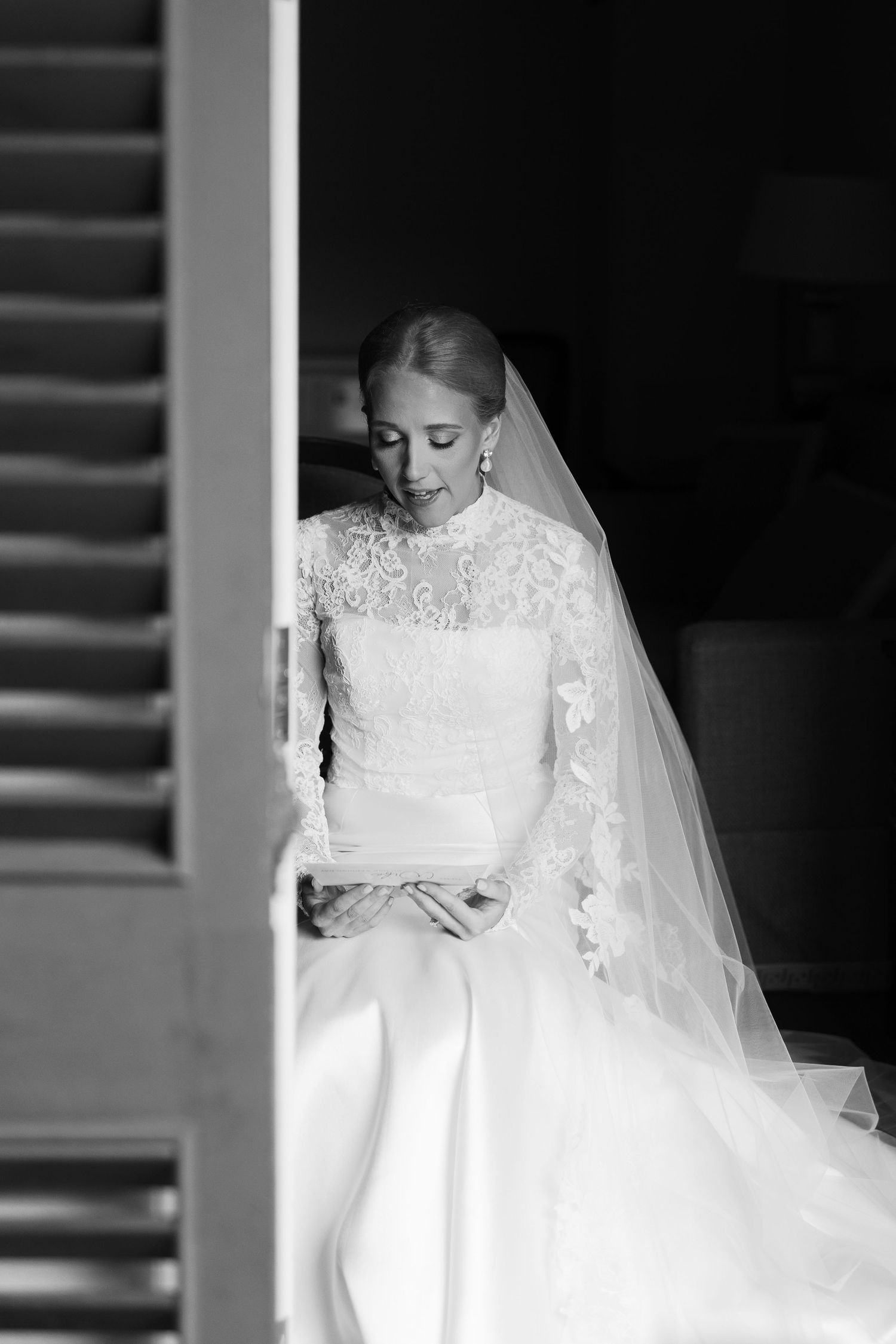 Black and white portrait series showing details of a classic lace wedding dress and veil.