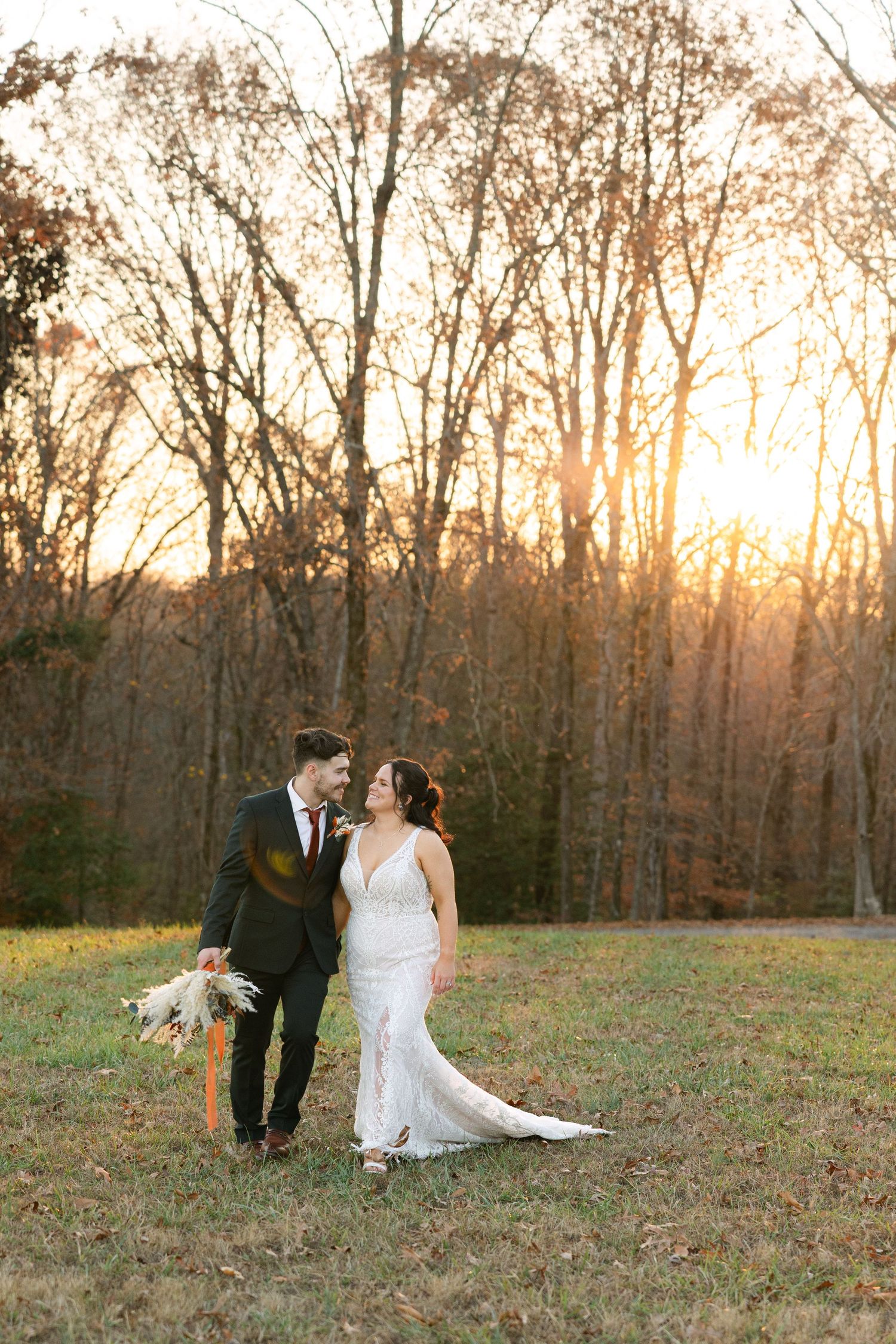 A couple walks together during the sunset on their wedding day in the South Carolina Upstate.