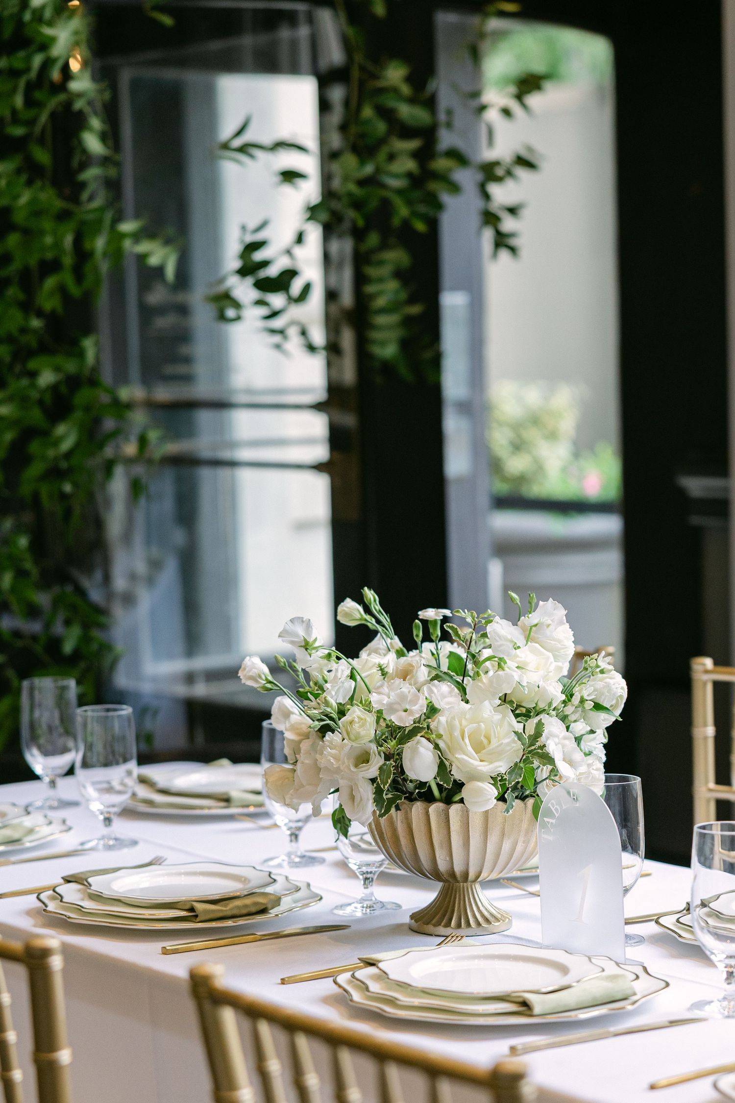 Wedding reception table with white florals and gold chairs at 1208 Washington Place in Columbia SC