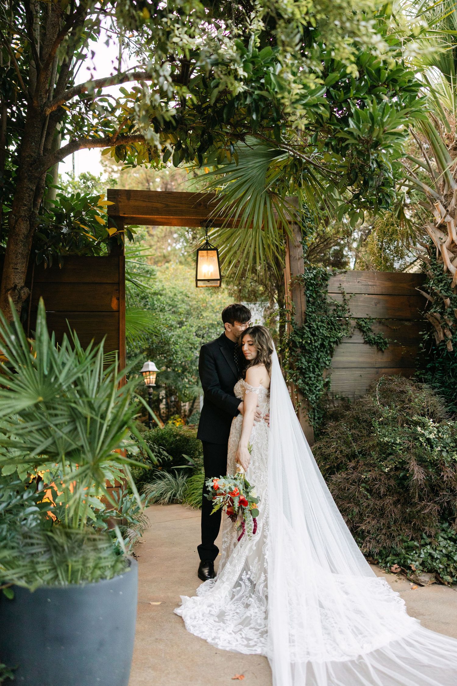 A bride faces her groom for a portrait that highlights the back of her dress at the River Road and Jasmine House in columbia, SC.