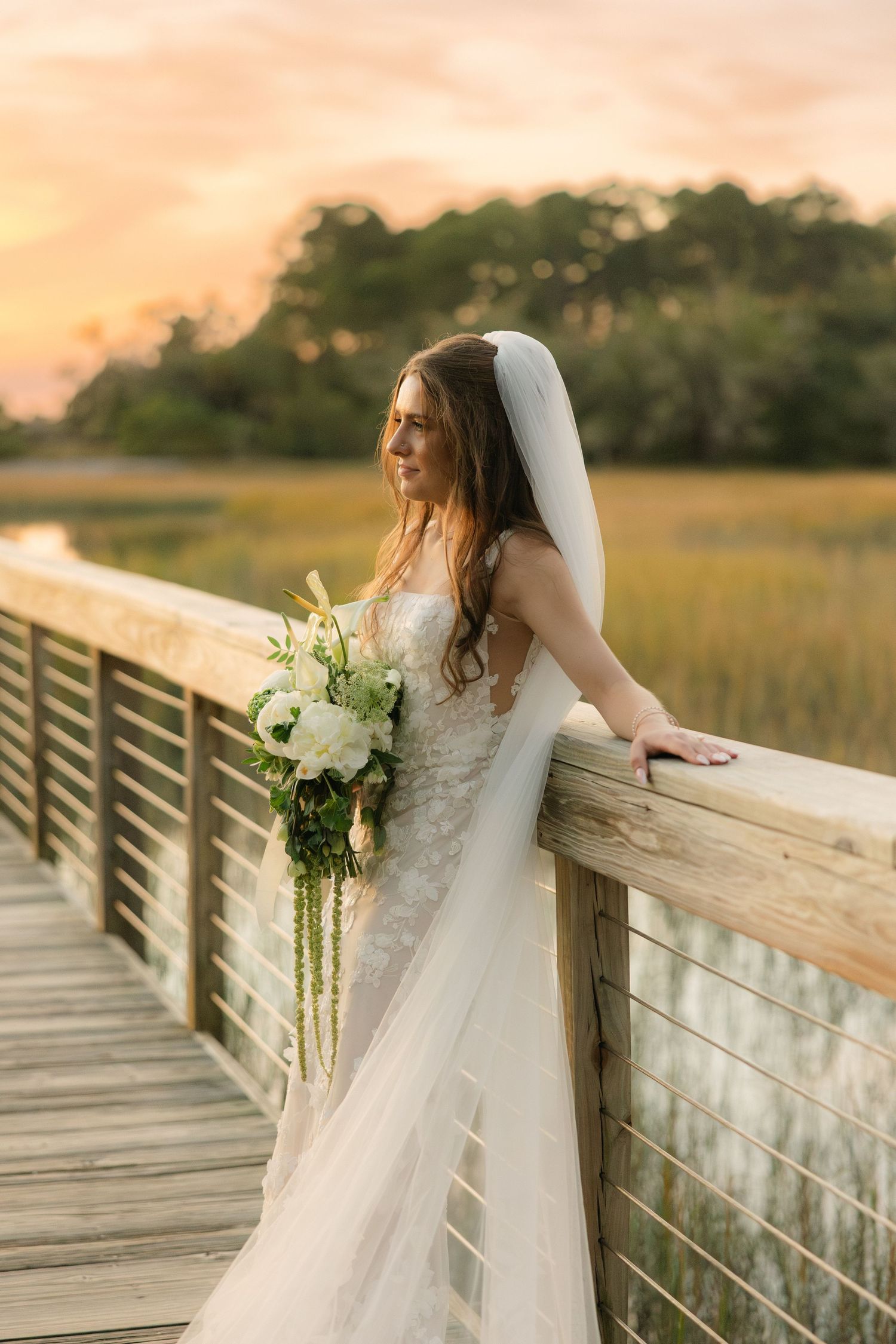 A bride gazes out over the marshy water in Hilton Head, SC.