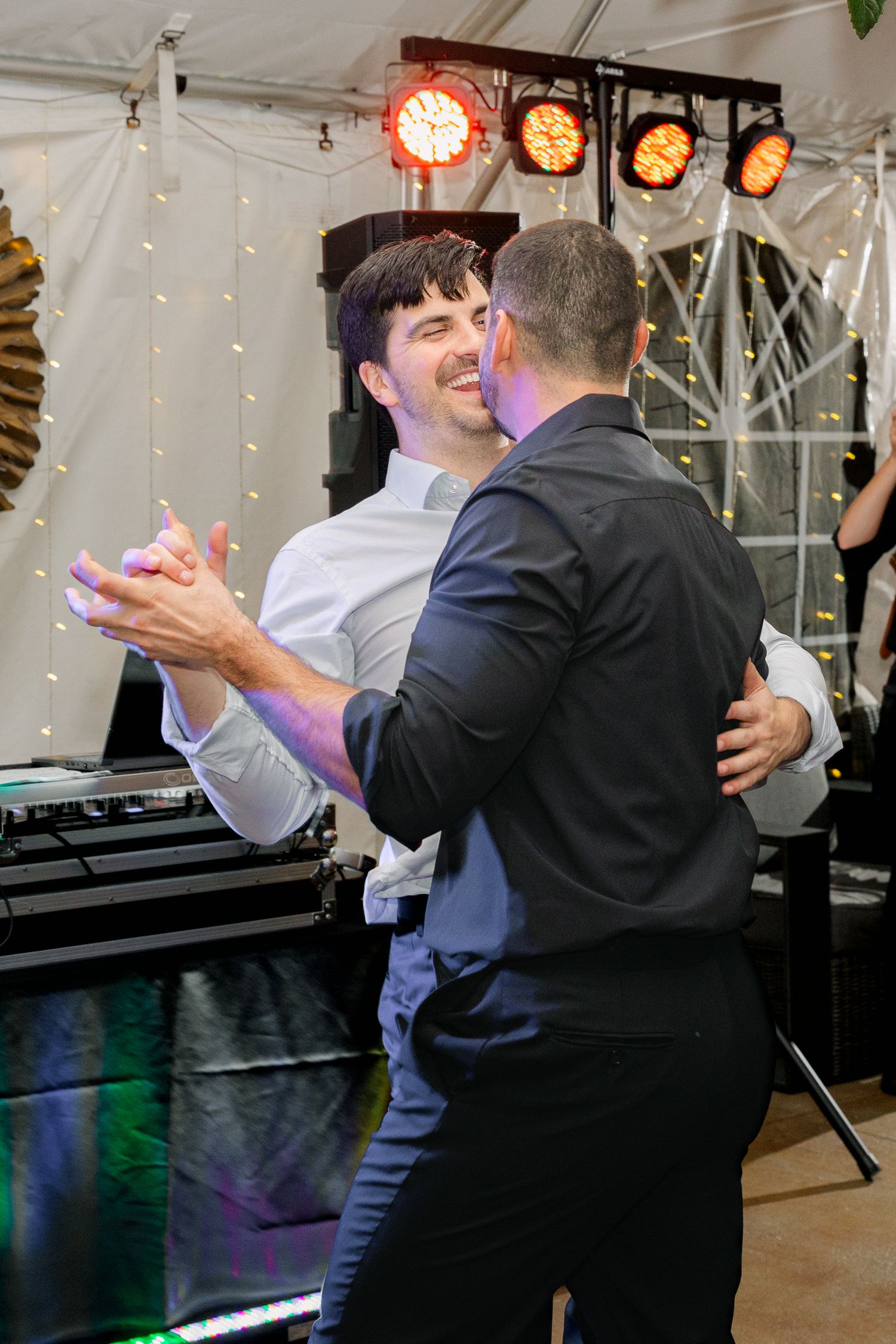 Two men dance with each other at a wedding reception at The River Road and Jasmine House in Columbia, South Carolina.