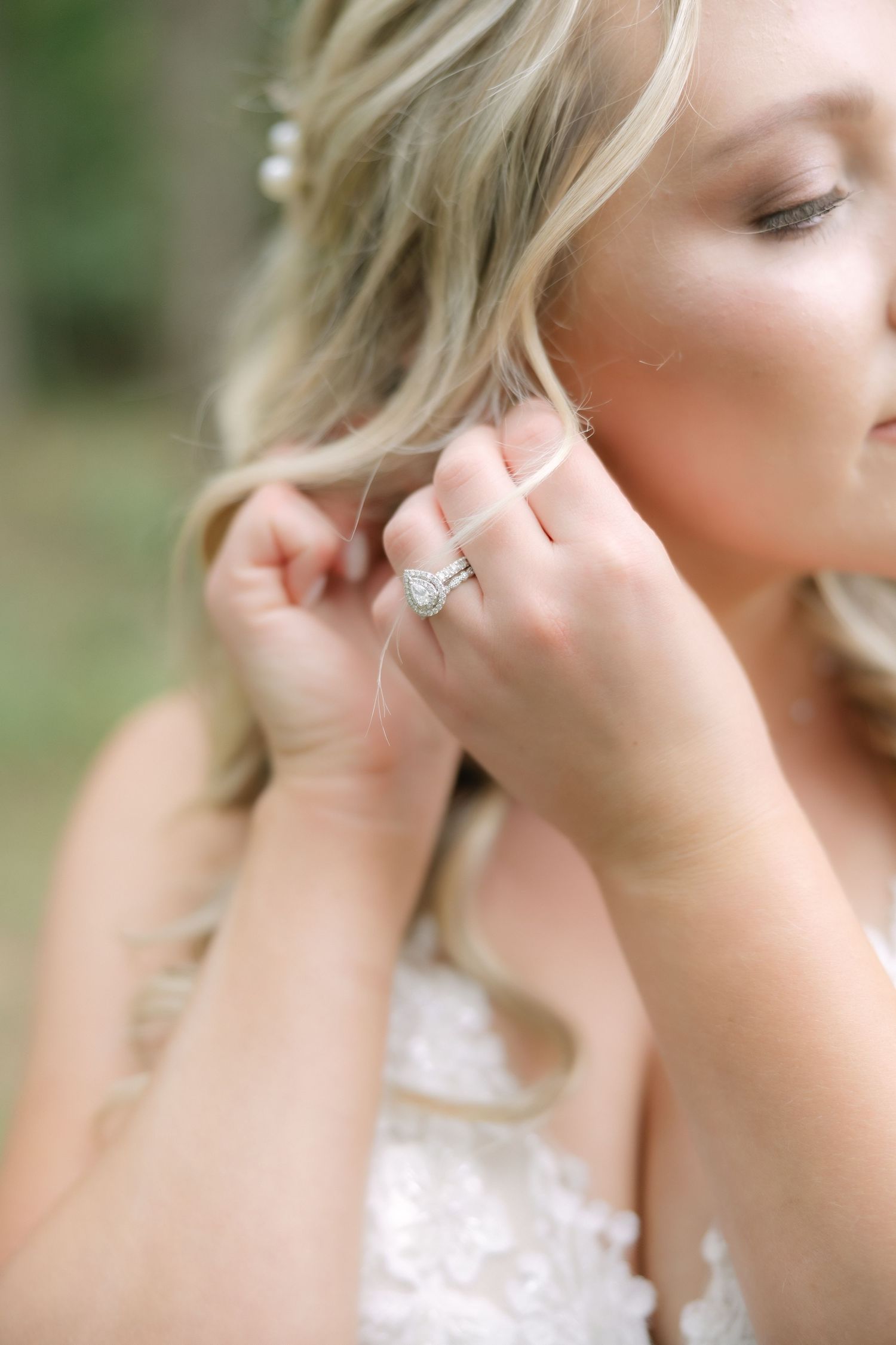 Bride putting on earrings during wedding morning getting ready in Columbia South Carolina
