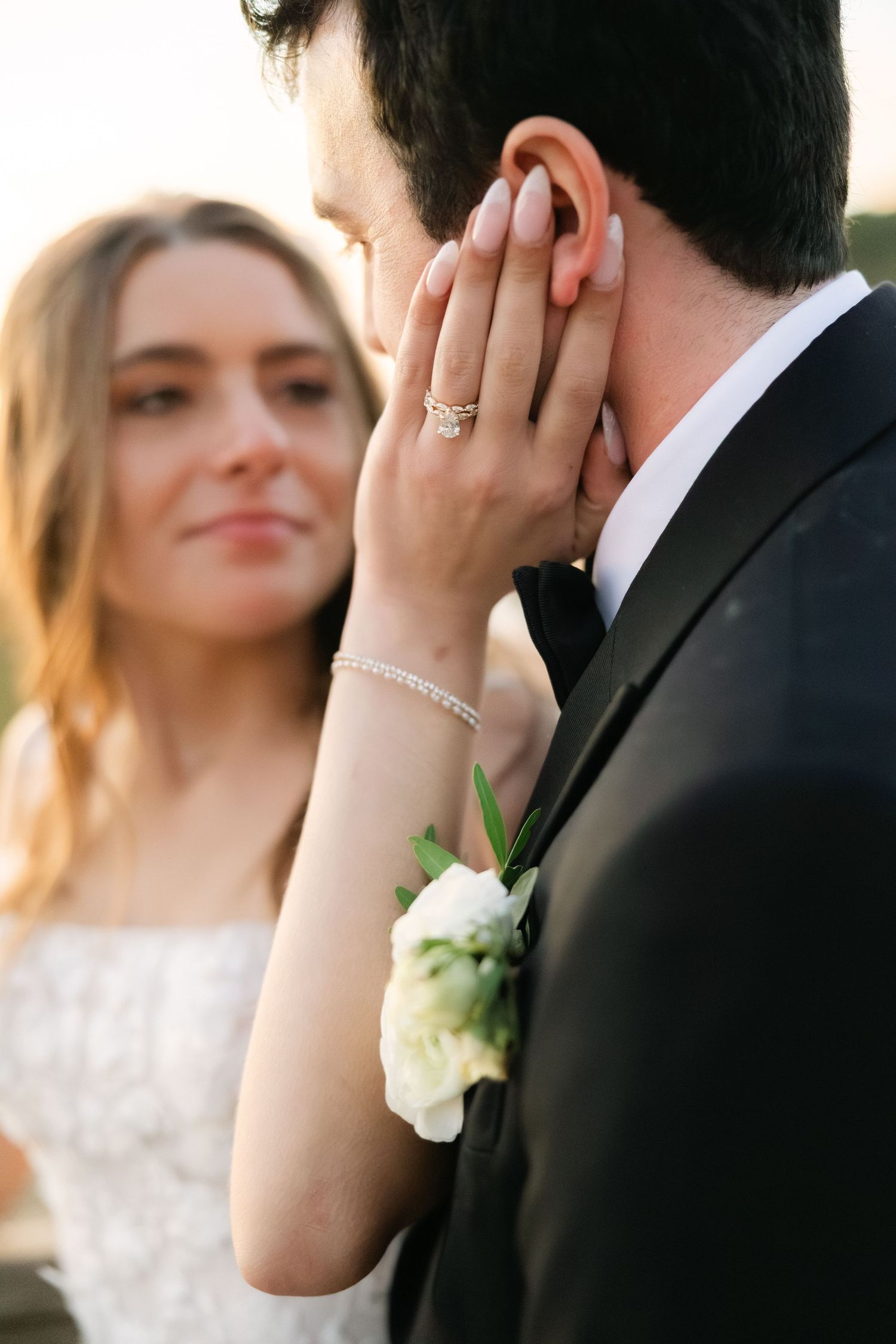 Bride holding her groom’s face during romantic outdoor wedding portrait in South Carolina