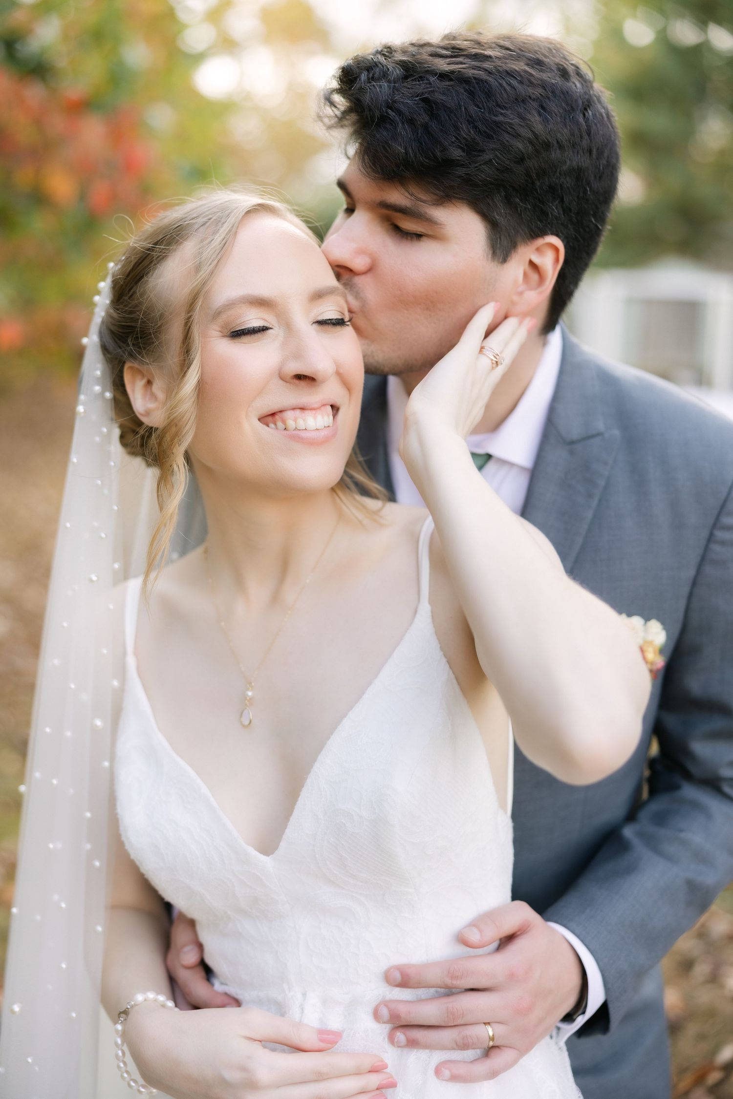 Bride holding her groom’s face during romantic outdoor wedding portrait in South Carolina