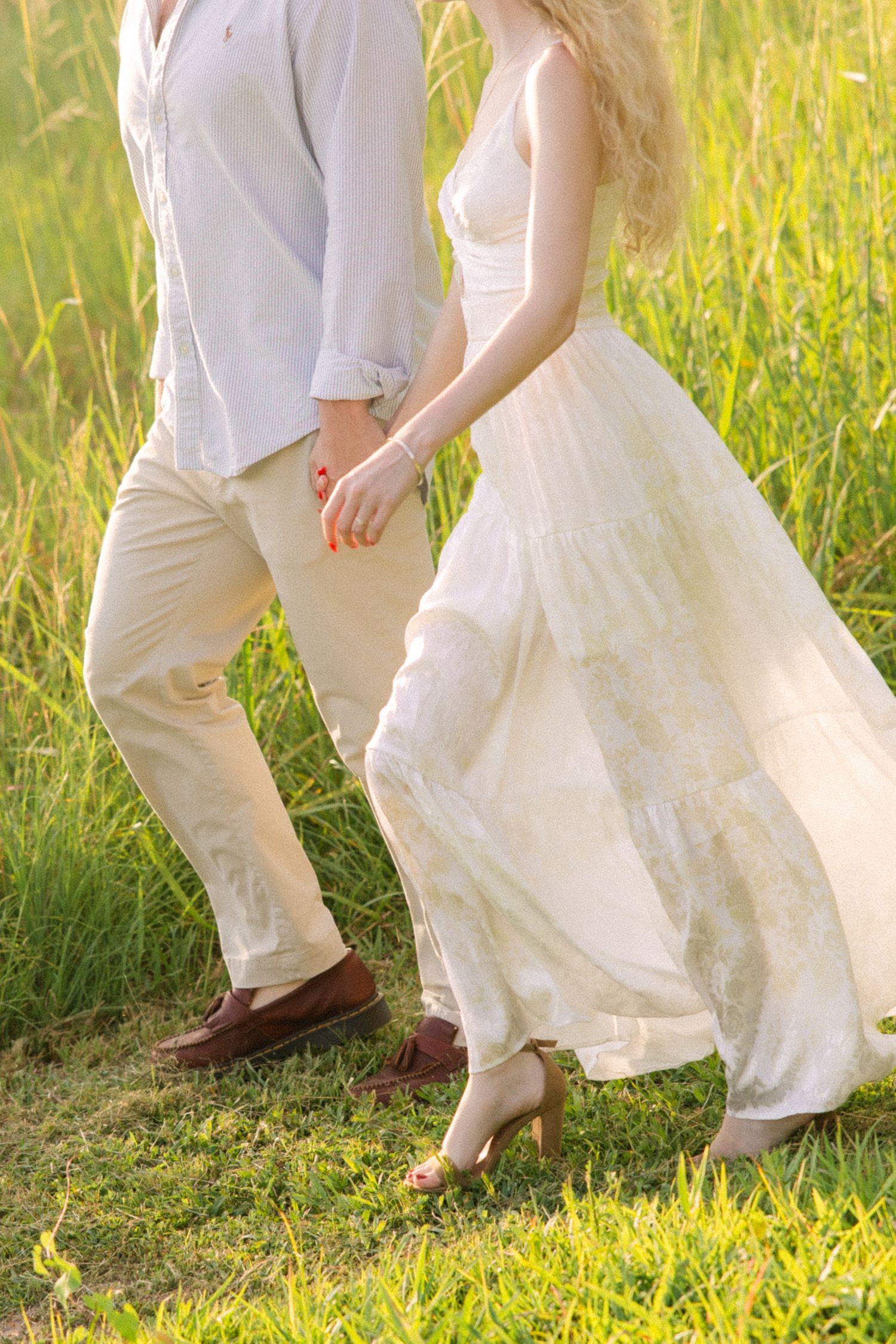 A detail photo of Emily and Harrison holding hands during their engagement session.