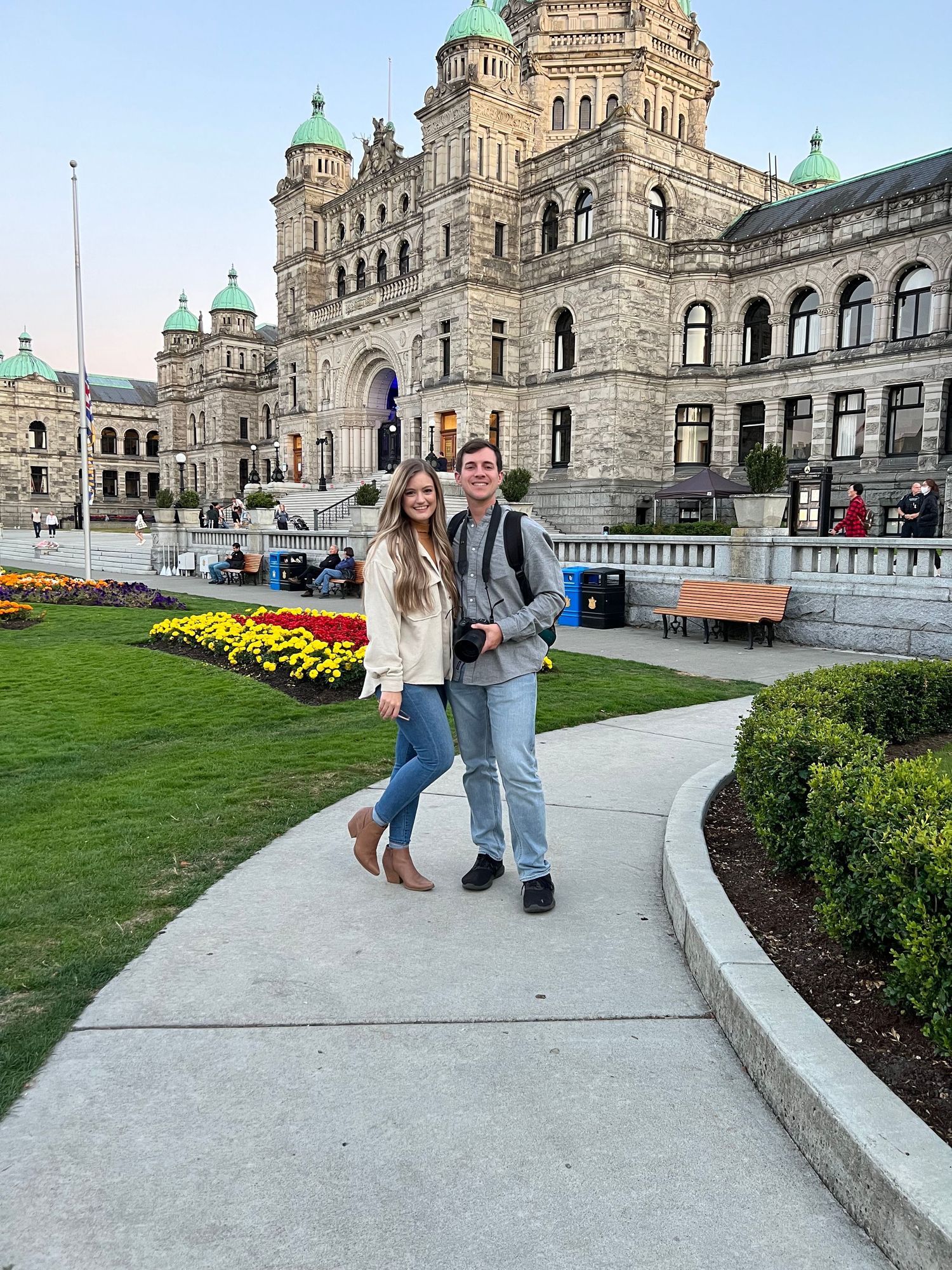 Samantha and Brady Anderson, owners of The Glitter Hour Photo Co. and Samantha & Brady Creative standing and smiling in front of a building.