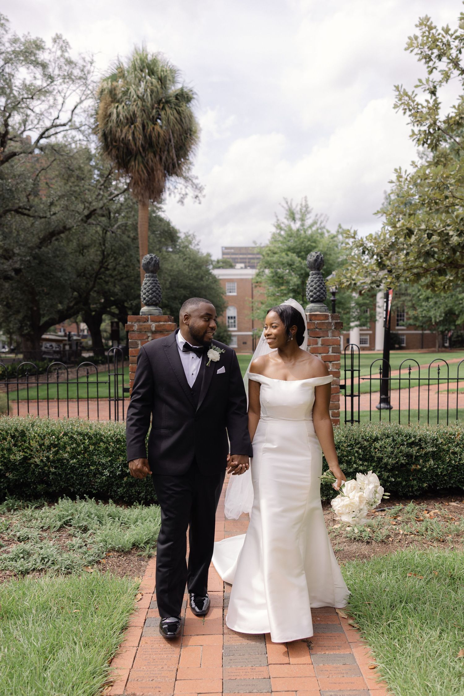 Bride and groom walking at the USC Horseshoe in Columbia South Carolina after their wedding ceremony