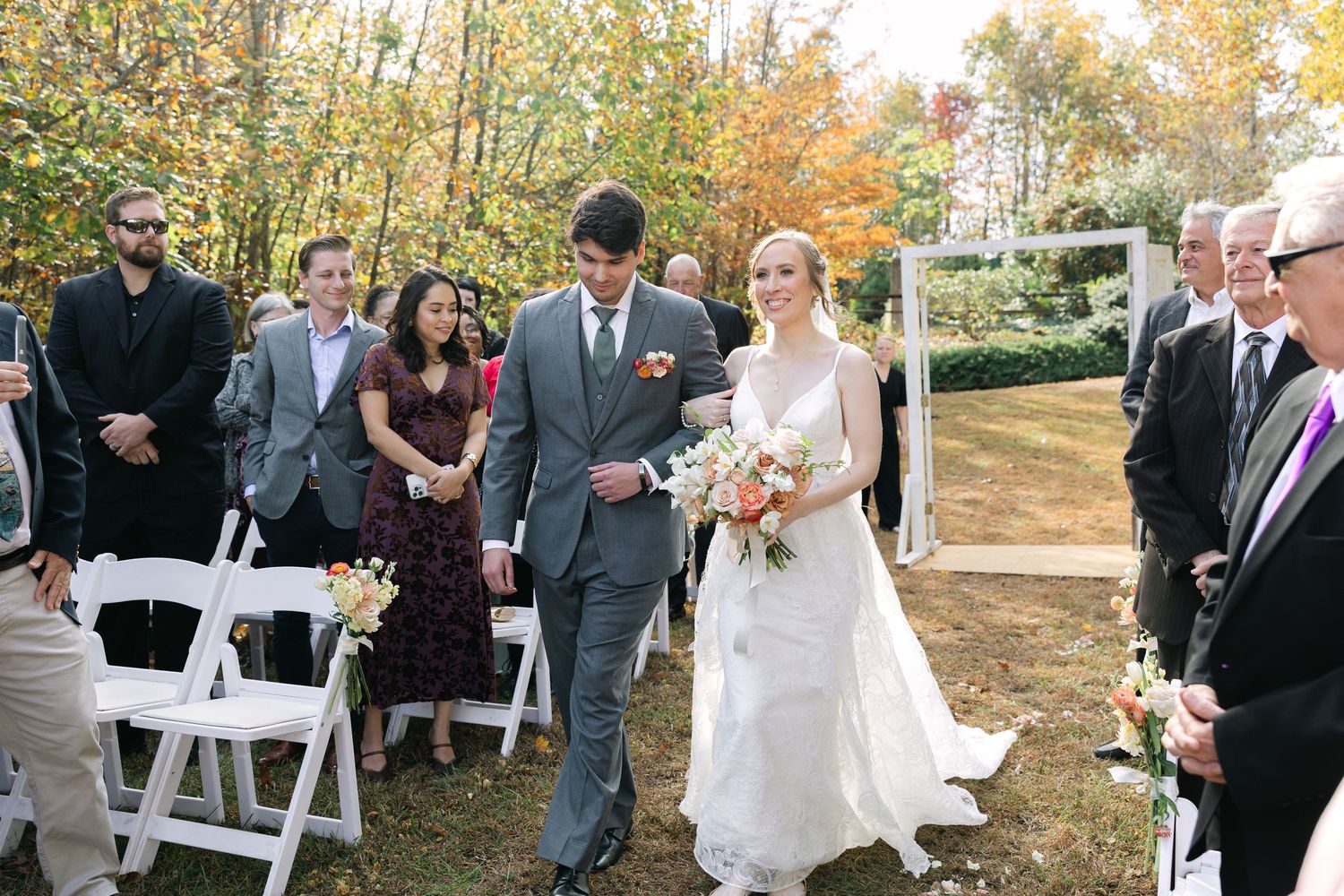A groom walks his down halfway down the aisle on their wedding day at Songhill Reserve in Landrum, SC.