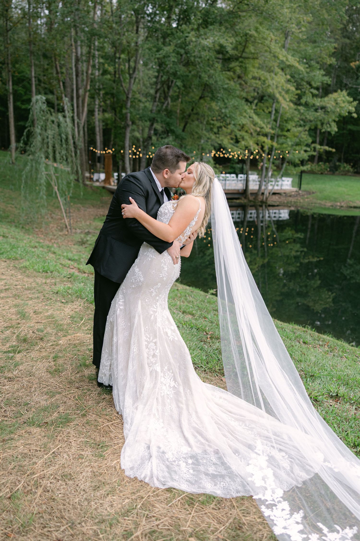 Bride and groom embracing by lakeside during editorial style South Carolina wedding portrait