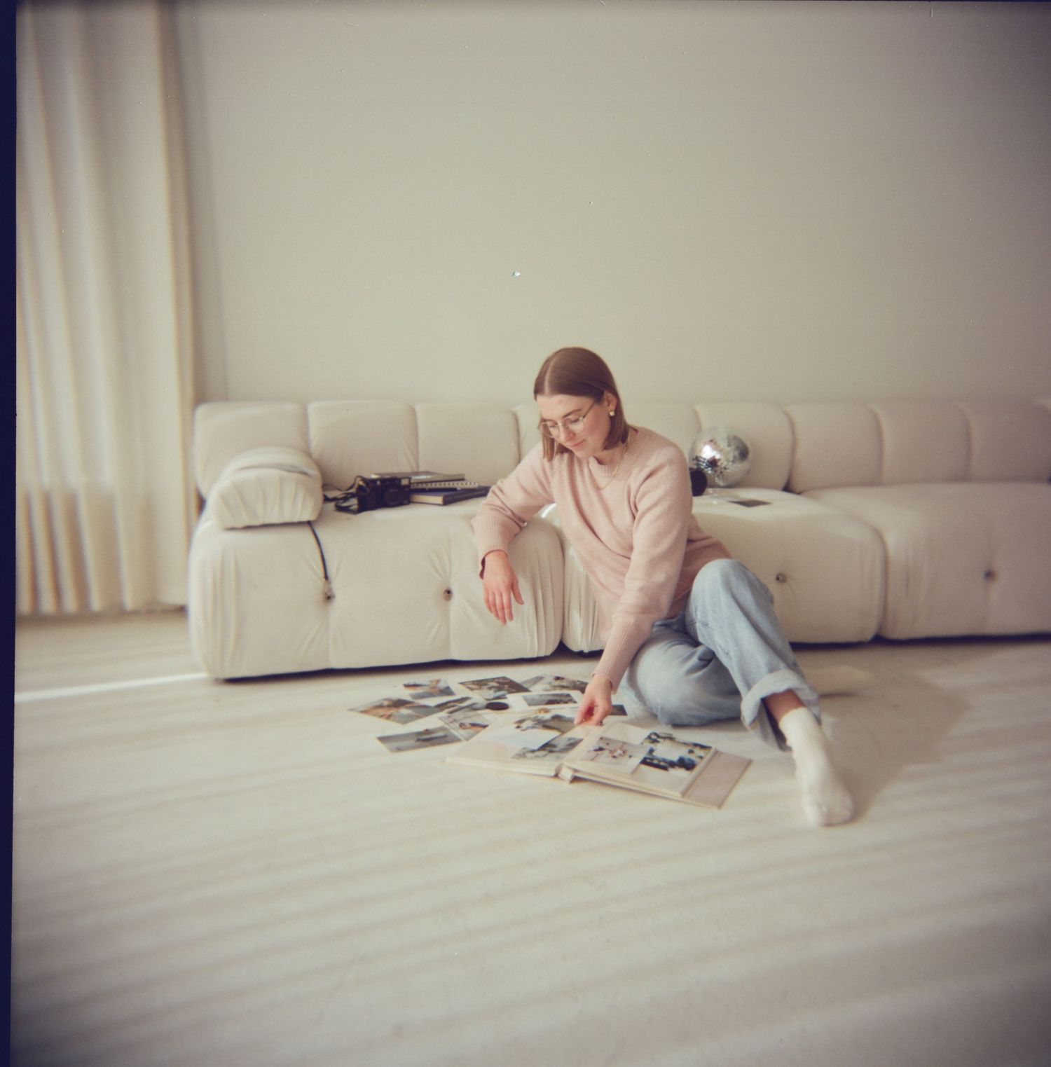 Person lying on floor working on jigsaw puzzle pieces scattered around them.