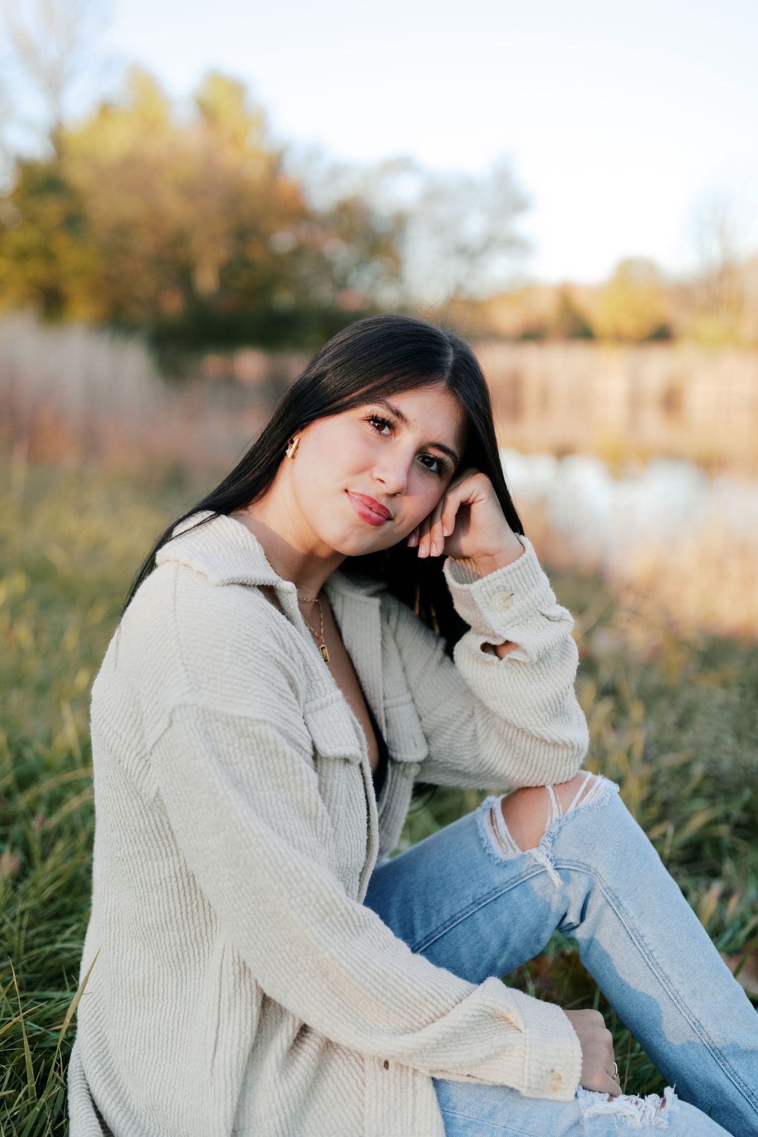 Relaxed outdoor portrait session in a field during golden hour.