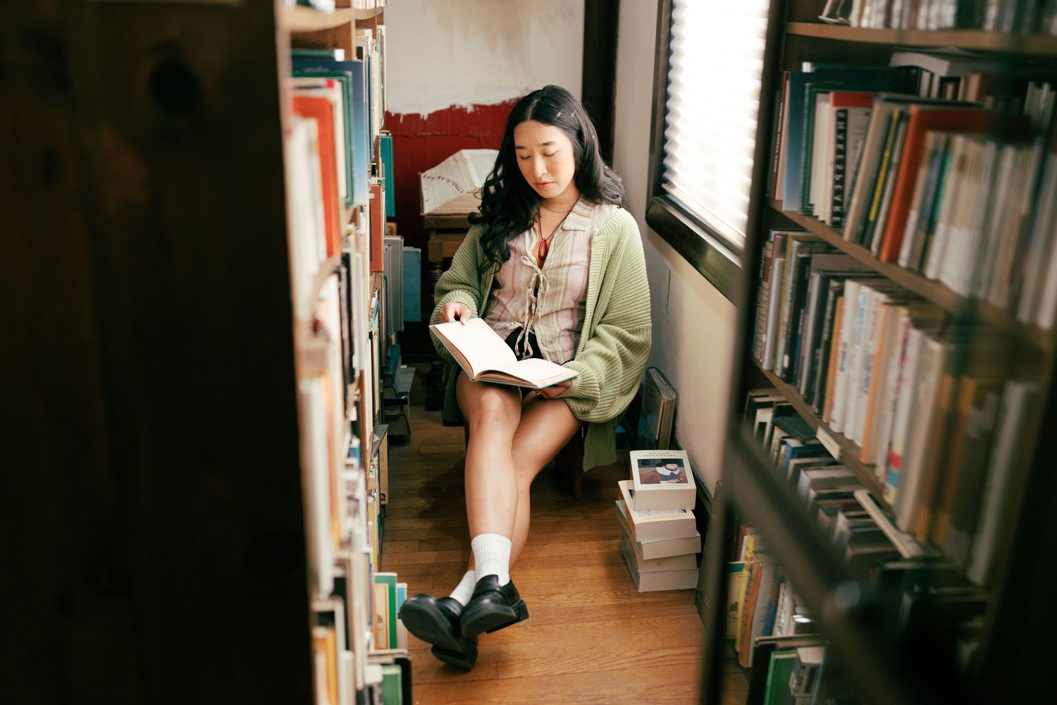 Library stacks with books lining both sides of a narrow walkway.