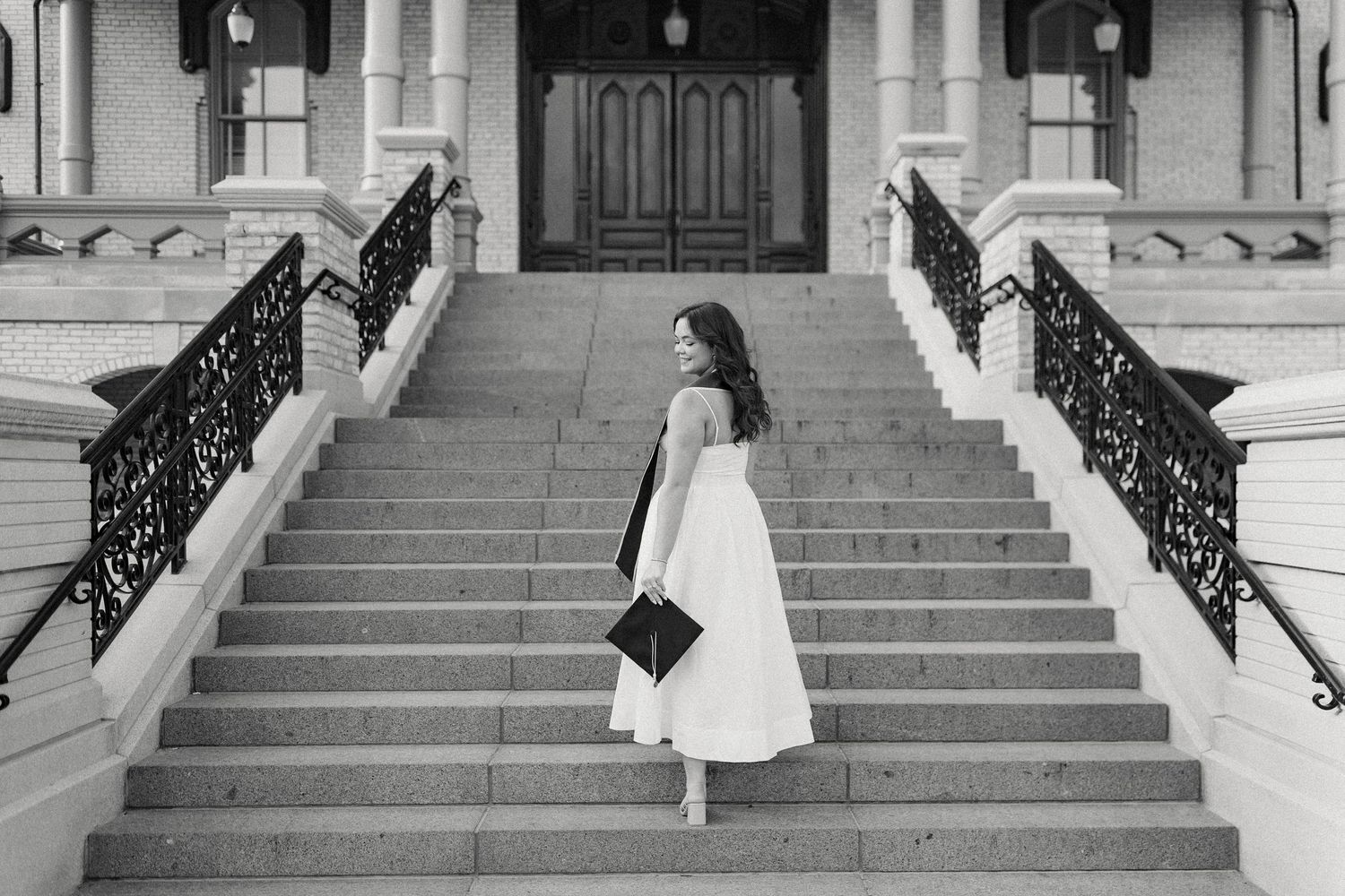 Series of playful poses on grand stone steps of historic building.