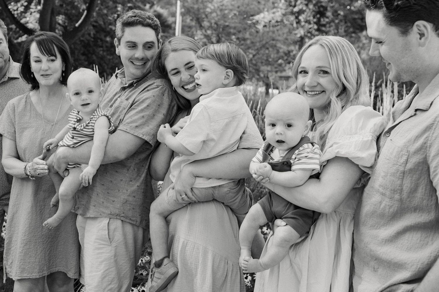 Black and white group photo of family members sharing candid moments together.