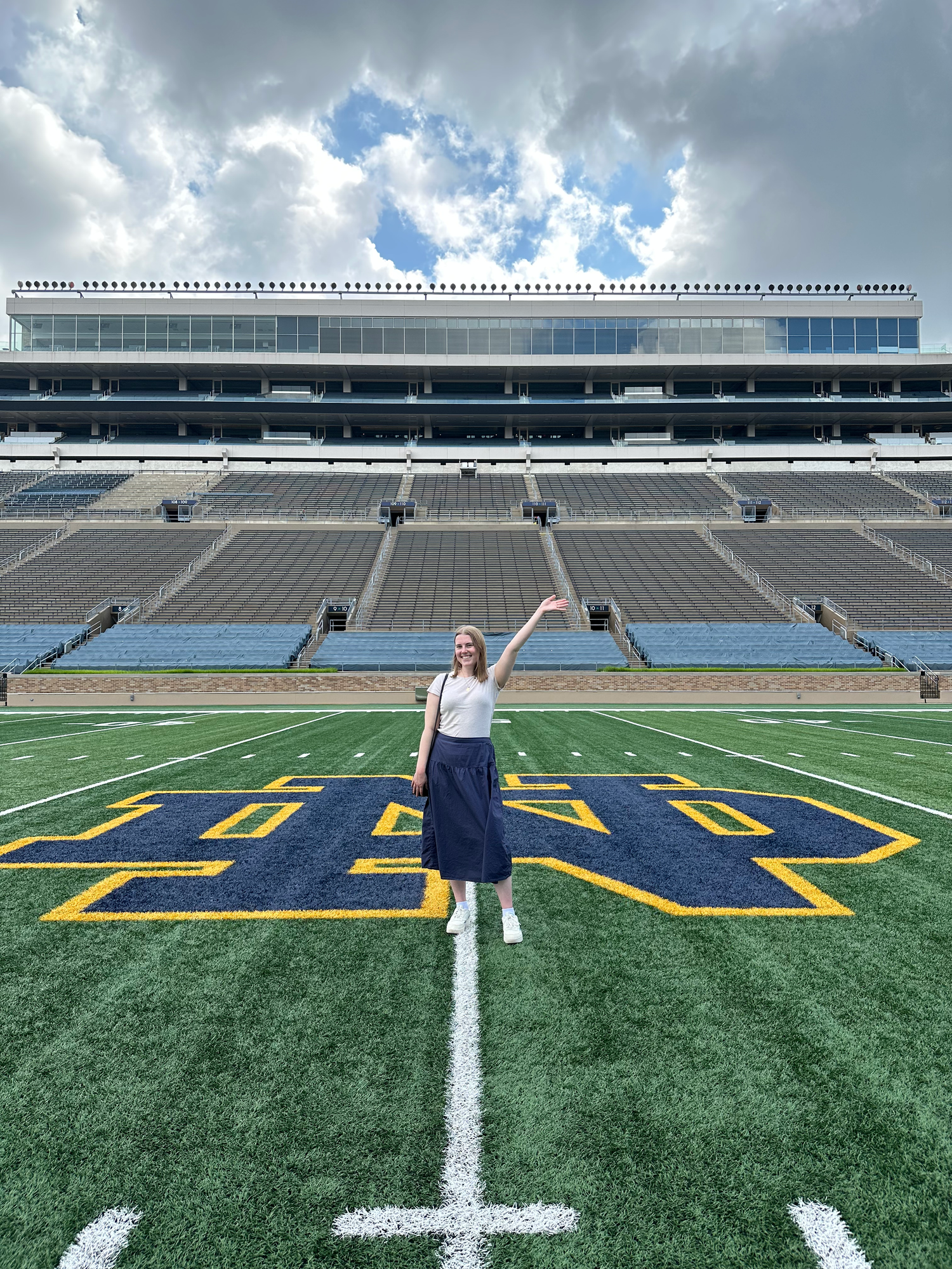 Series of photos showing a person walking across a football field with stadium seating in the background.