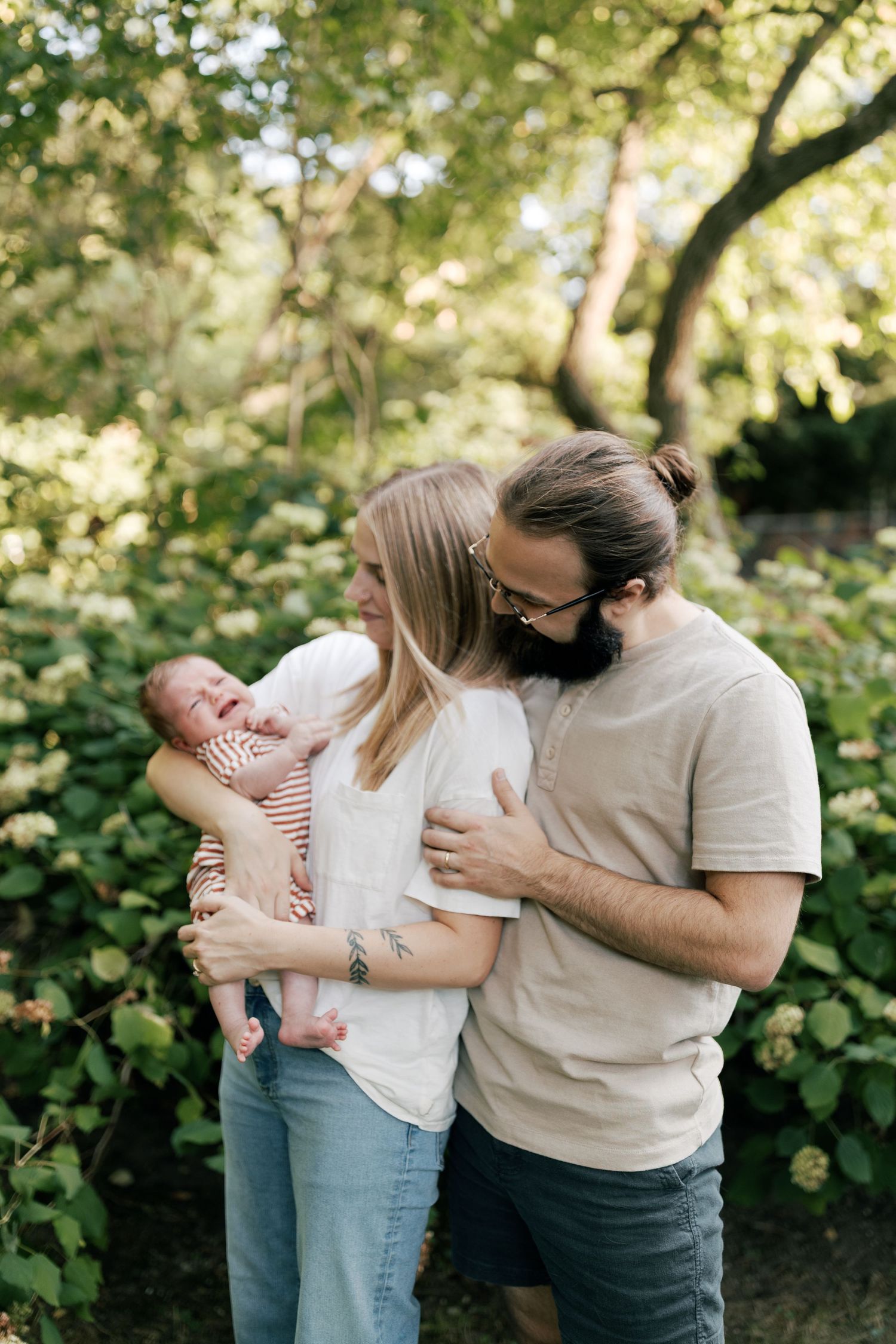 Sweet family moments captured in a series of casual outdoor photos with greenery backdrop.