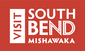 Visit South Bend Mishawaka official tourism logo on a bold red background with white and dark text.