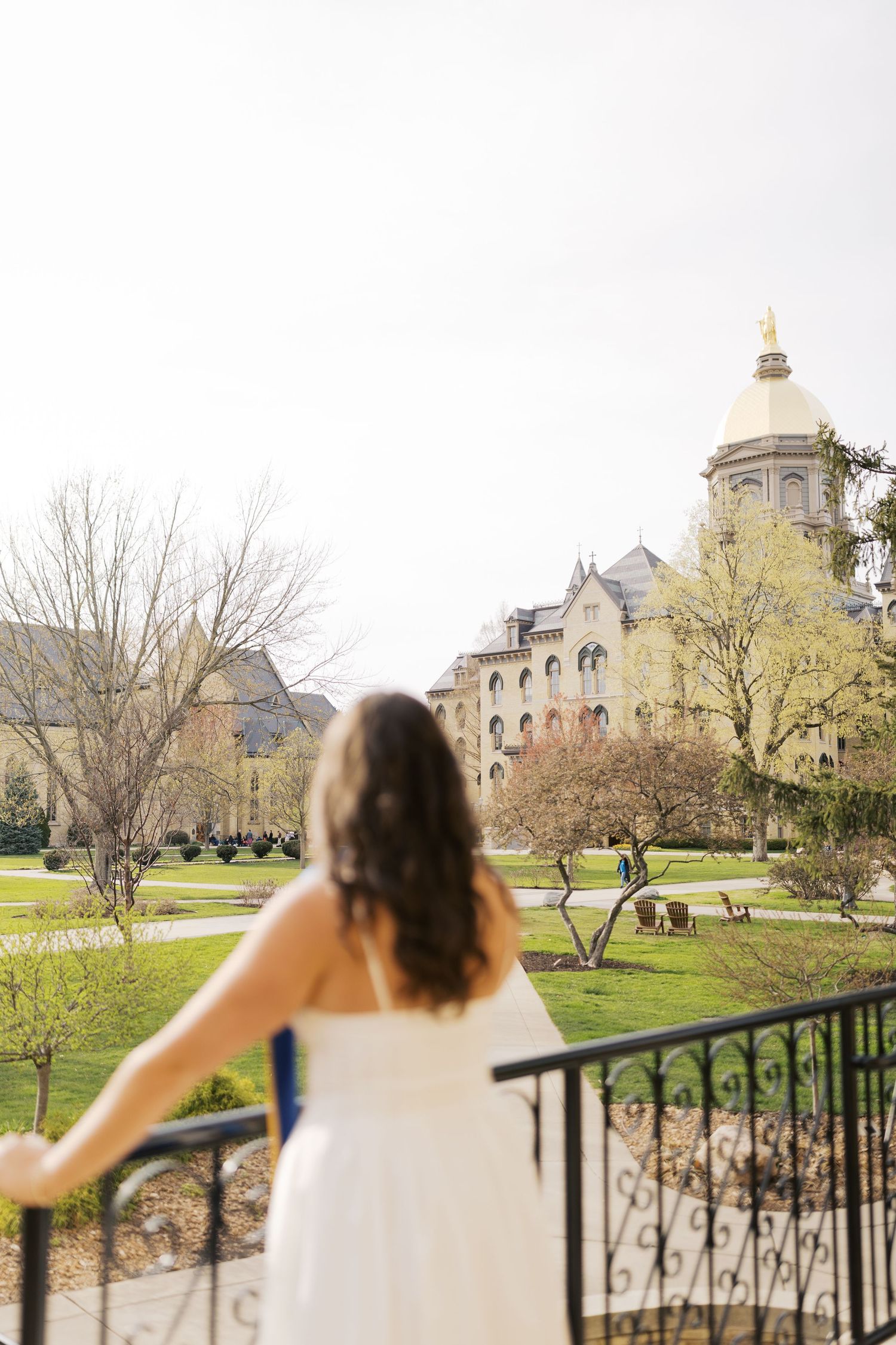 Three connected shots of a vintage balcony overlooking a scenic university campus with historic architecture.