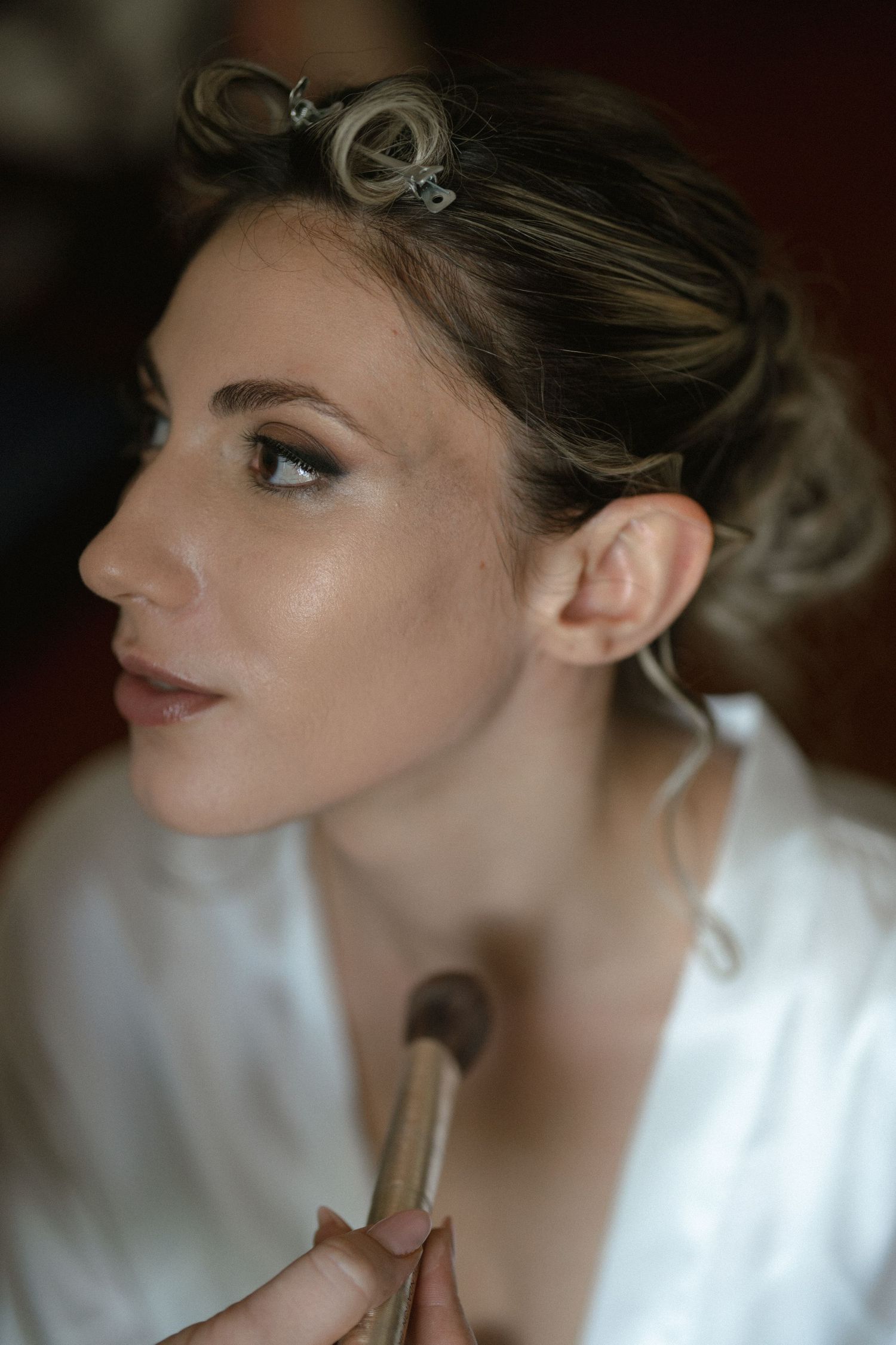 Close-up beauty shots showing elegant makeup and hair styling details.