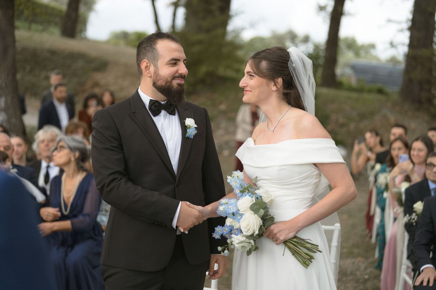 Bride and groom exchanging vows during outdoor wedding ceremony.