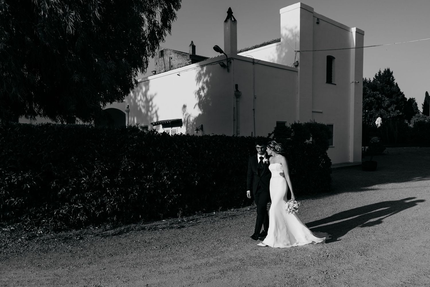 Black and white wedding photos taken against architectural shadows.