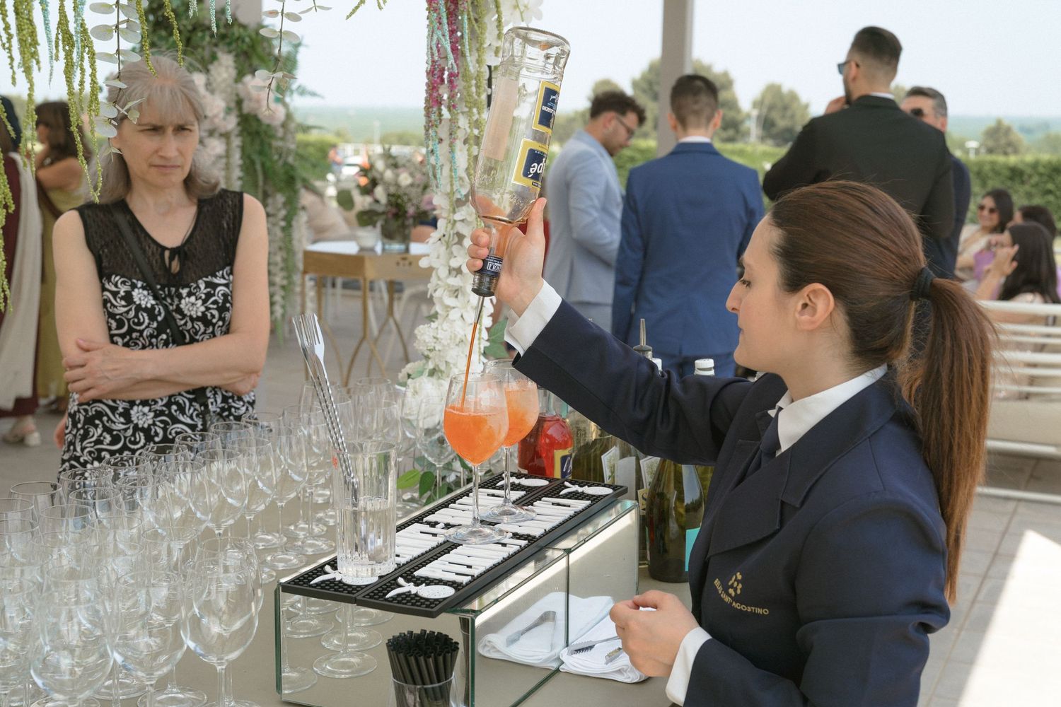 Elegant wine glasses lined up at a wedding reception bar.