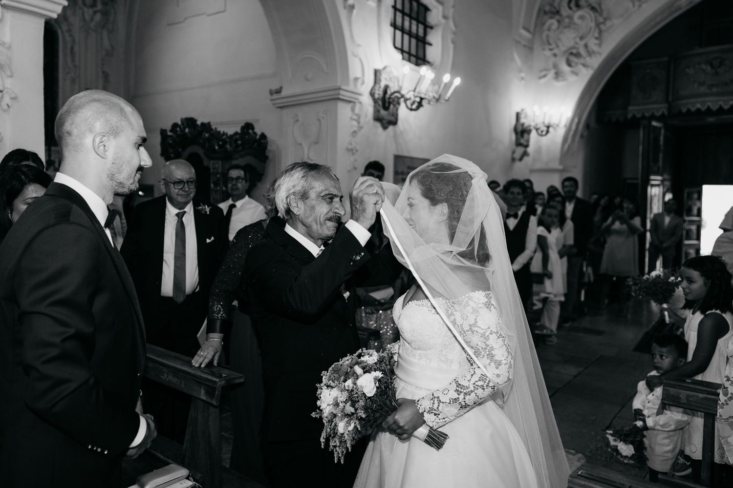 Elegant wedding ceremony in ornate church with vaulted ceilings.