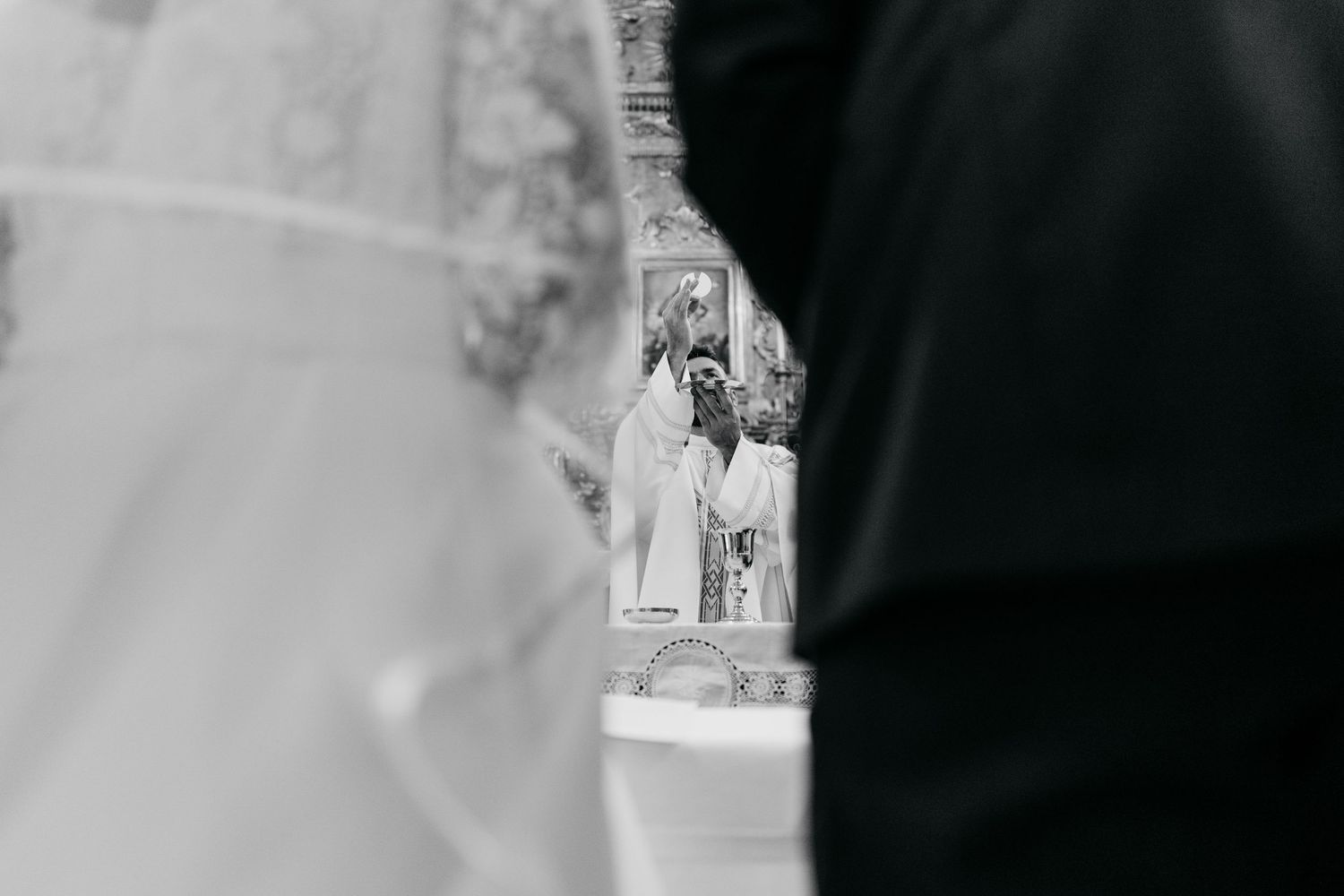 Black and white detail shots of a traditional church wedding ceremony.