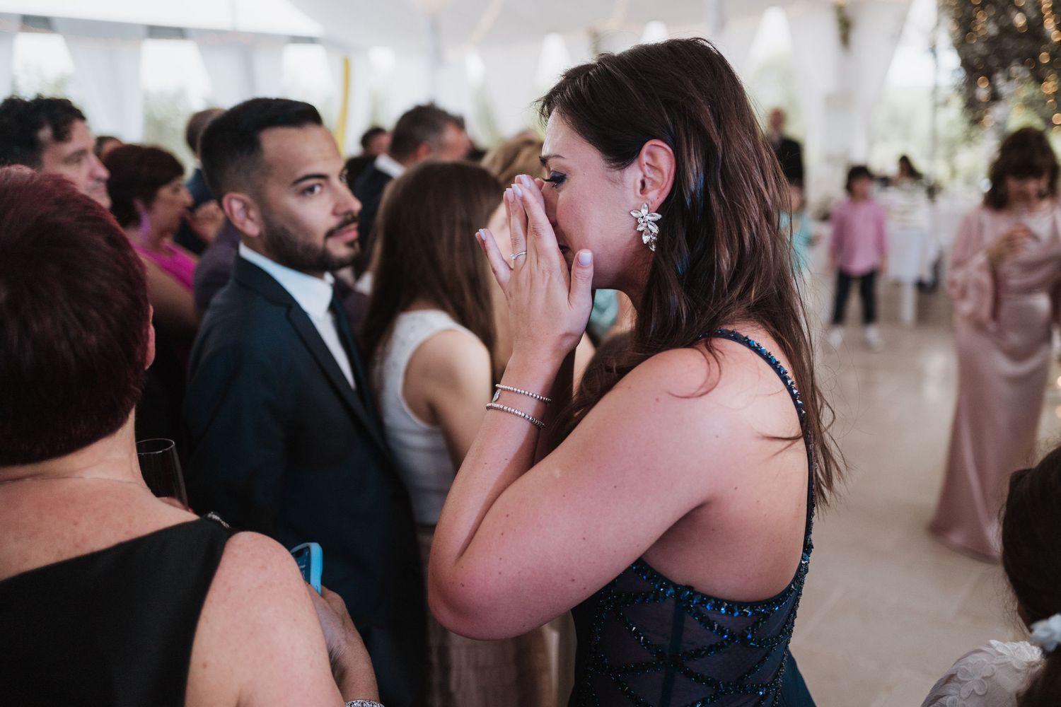 Wedding reception guests sharing an emotional moment during the celebration.