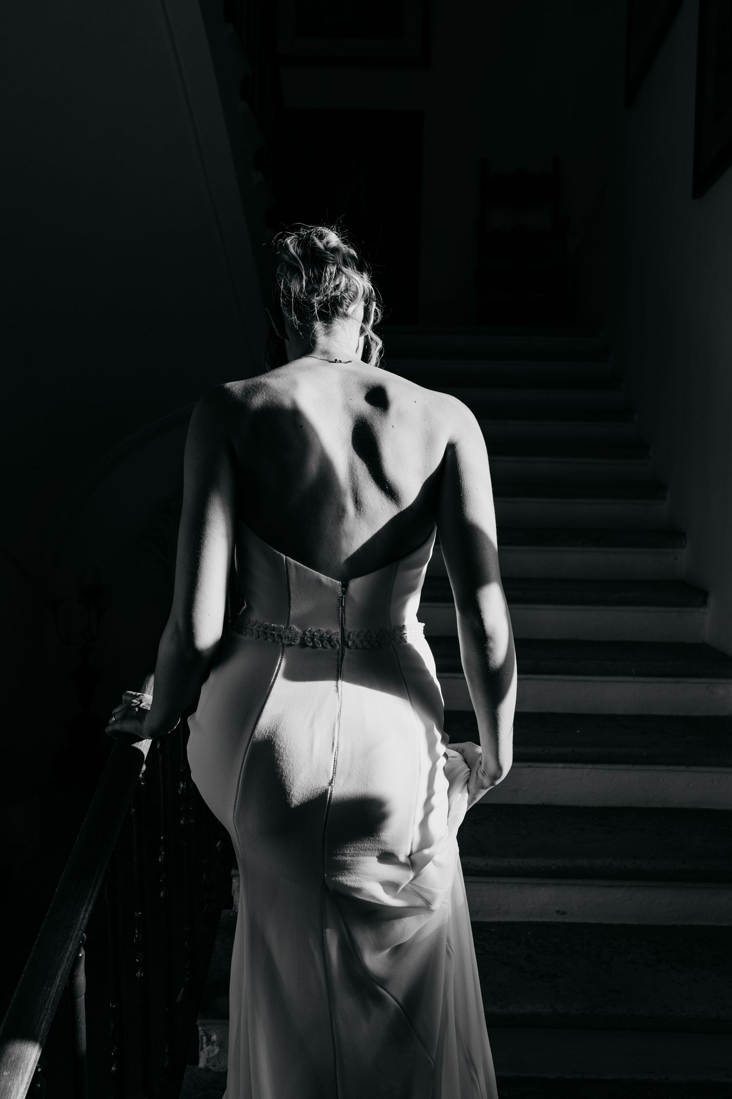 Dramatic black and white photo showing the back details of formal evening wear.