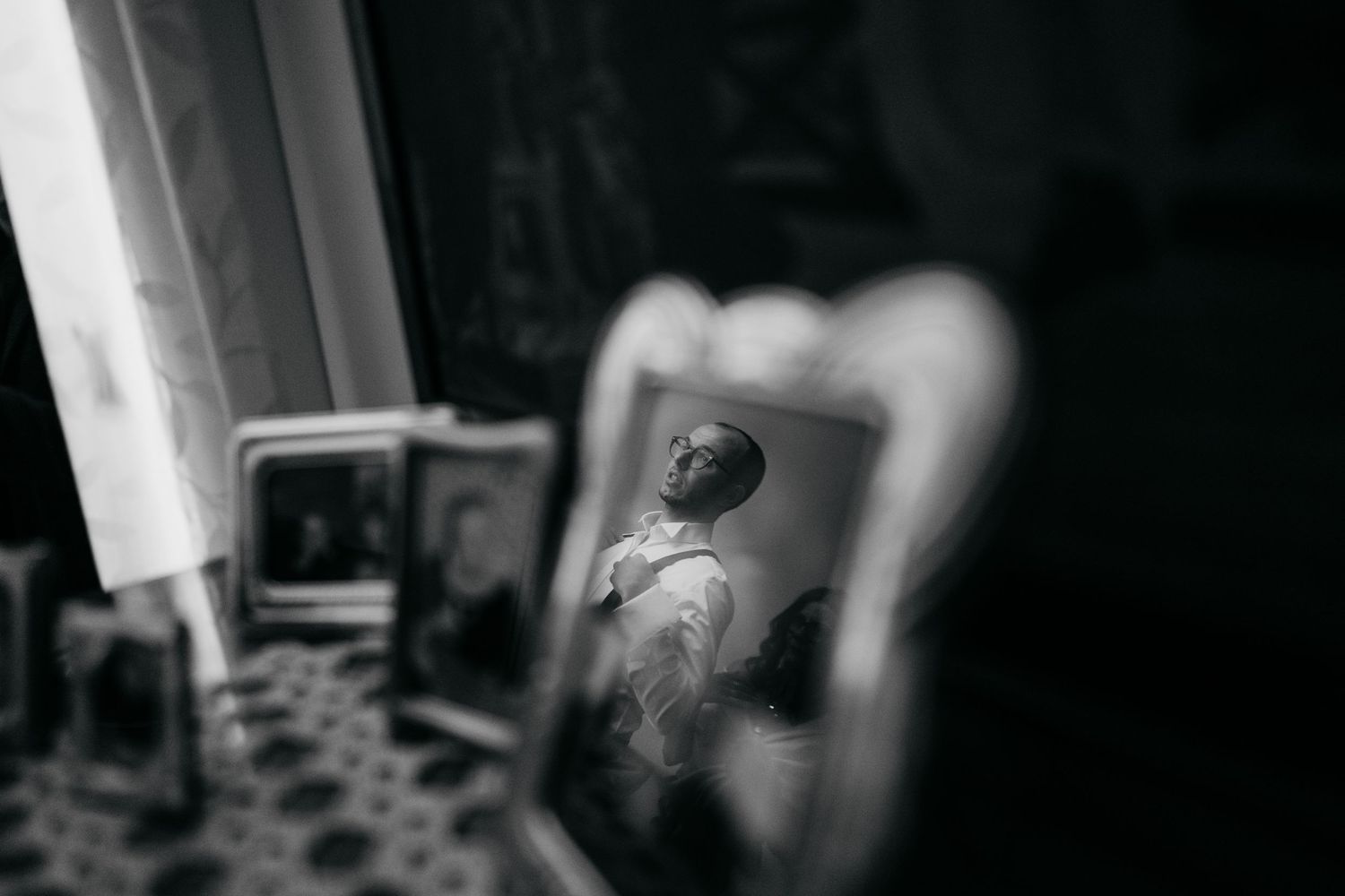 Artistic black and white photograph showing reflection in mirror with soft focus.