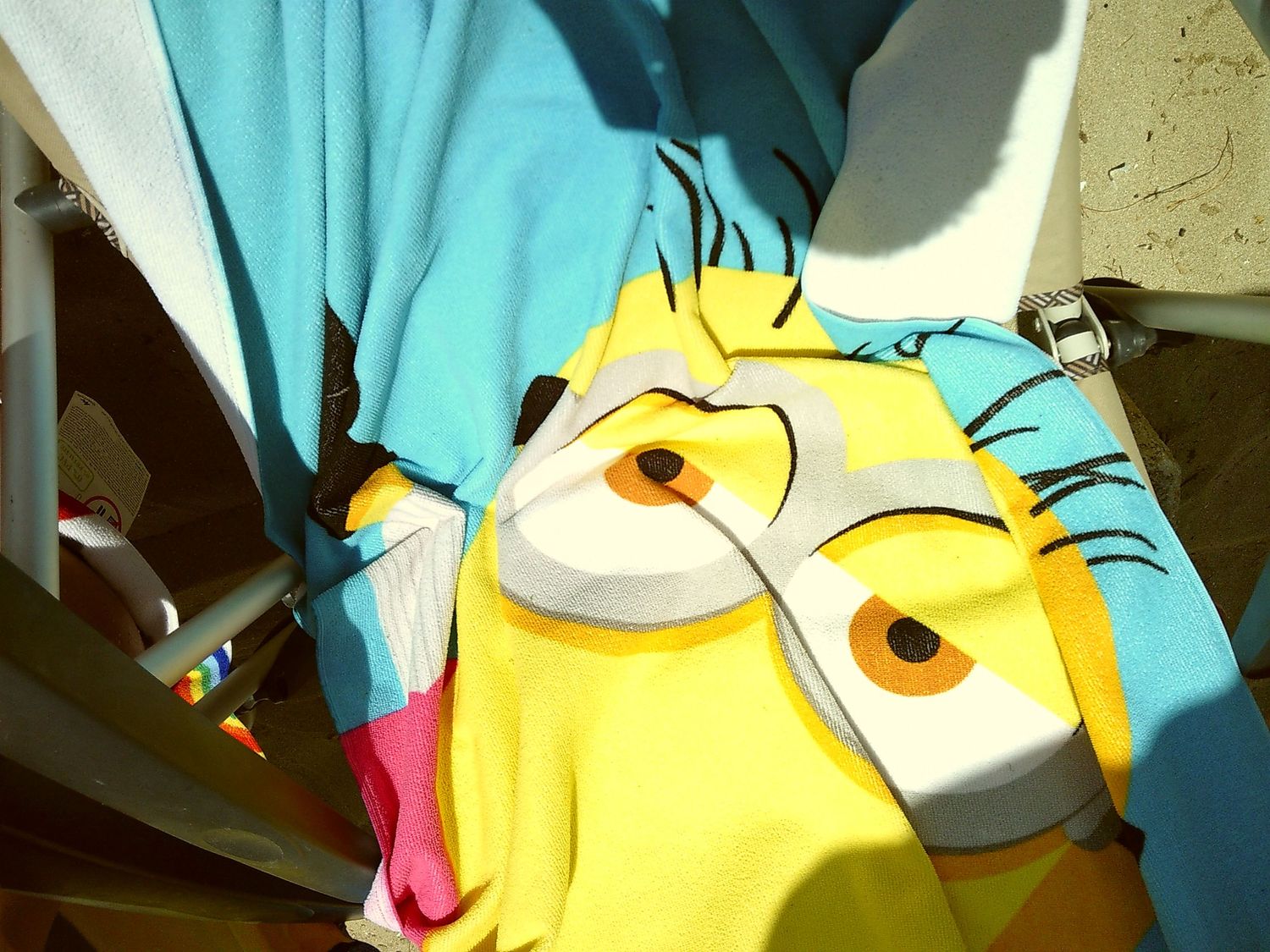 A close-up view of a Minion character plush toy showing its distinctive yellow face and googly eyes.