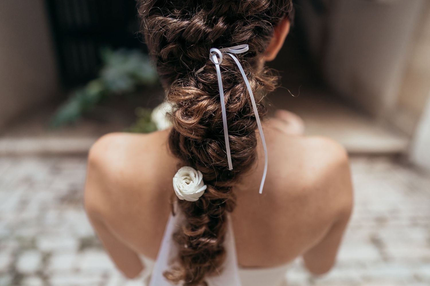 Close-up view of an elegant bridal hairstyle with ribbon details.