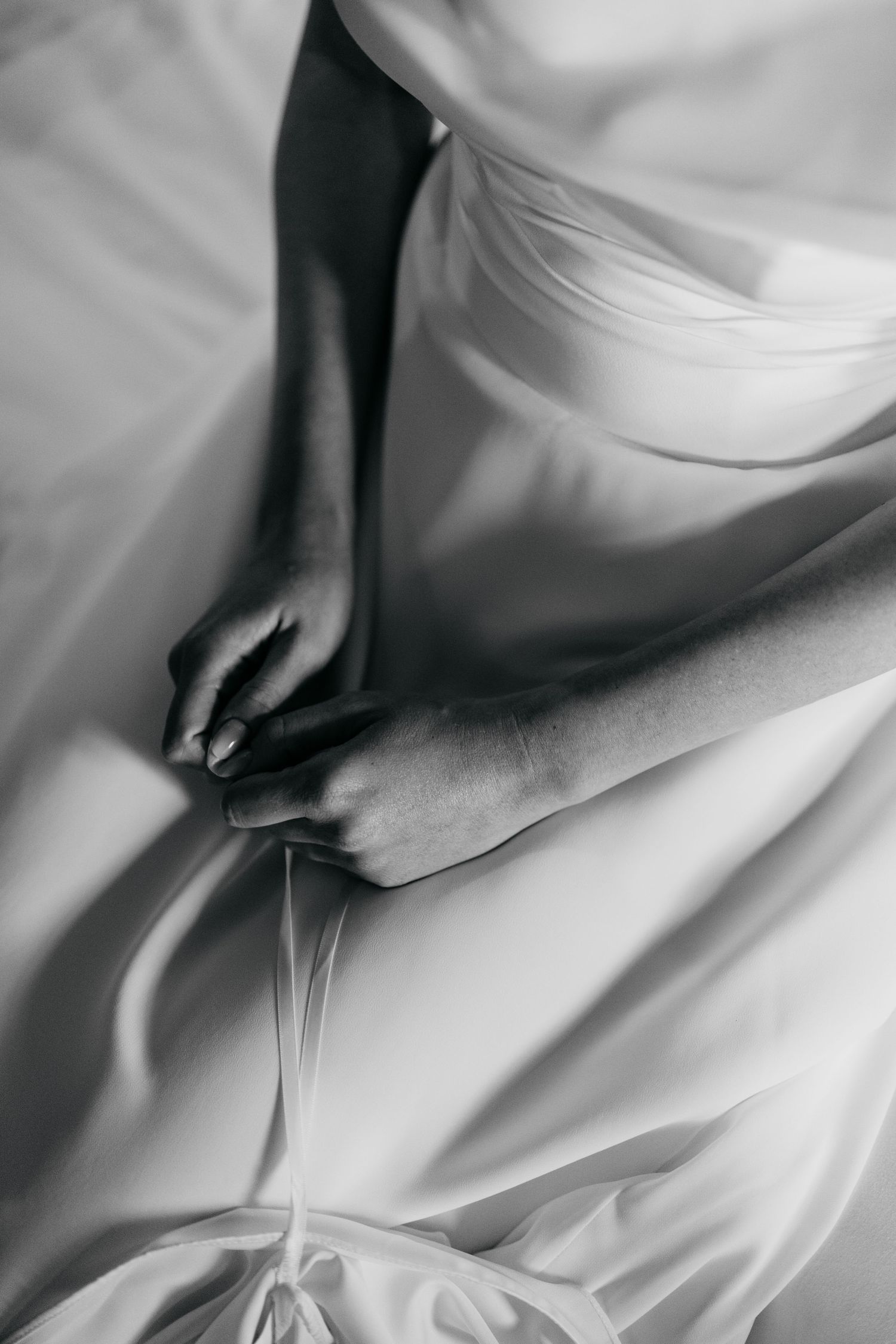 Abstract black and white close-up of flowing white fabric details.