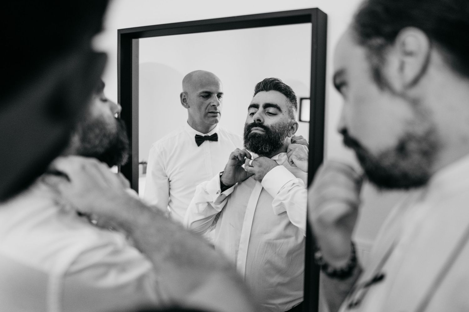 Reflection in mirror shows formal grooming preparation.