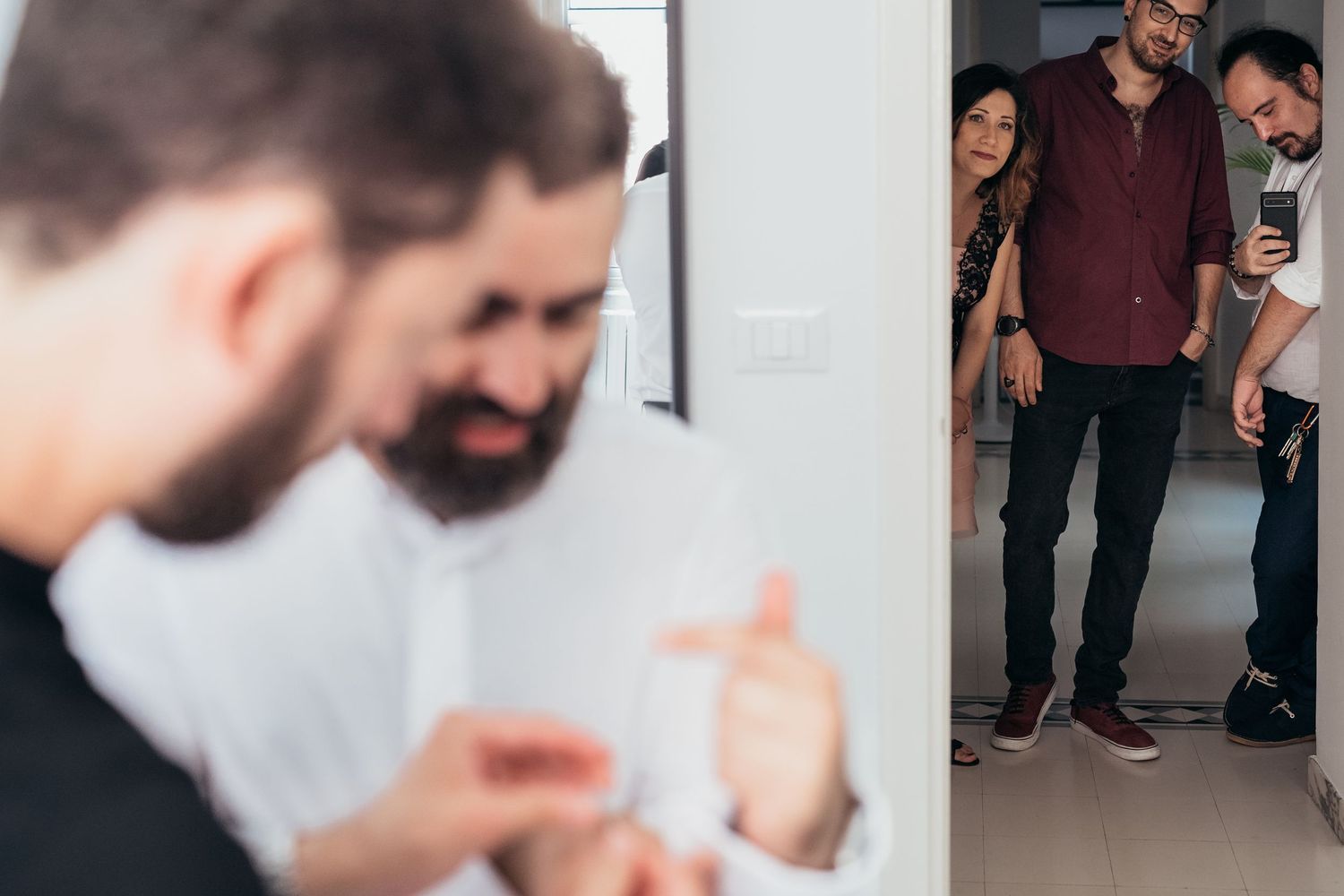 People gathered in a hallway having an animated discussion.