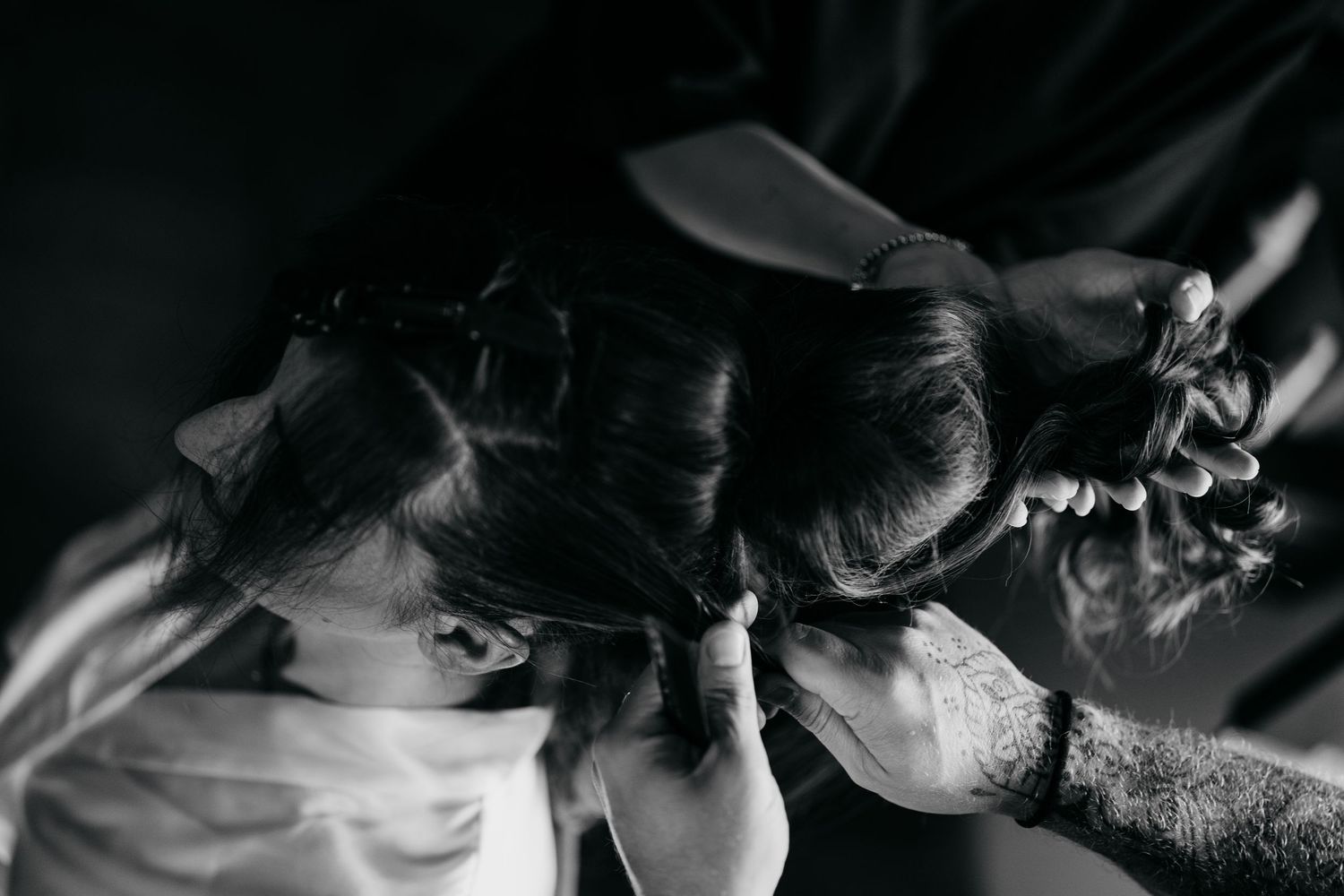 A dramatic black and white photo series showing the process of mixing and preparing cocktails at a bar.