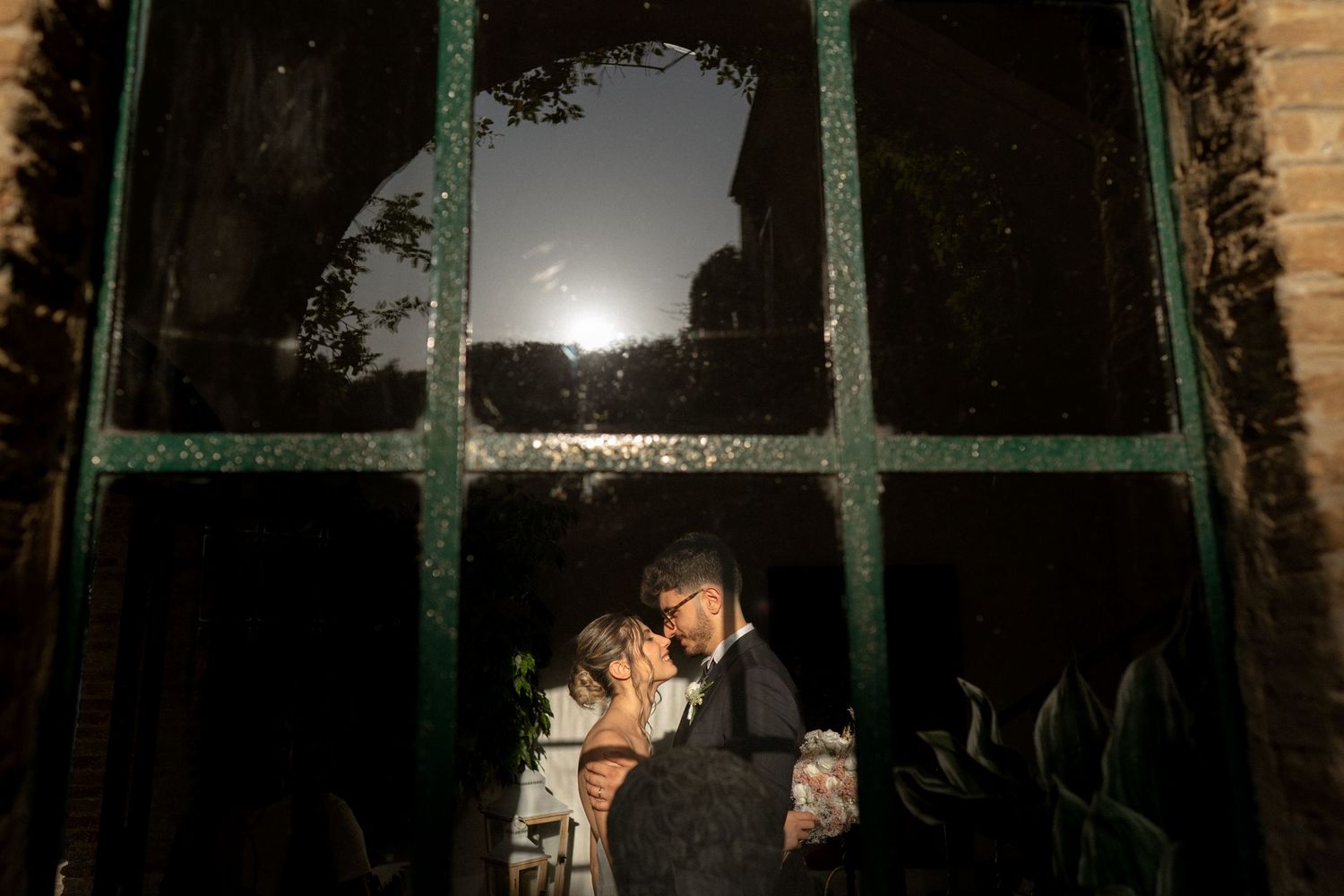 Romantic sunset silhouette through vintage window panes.