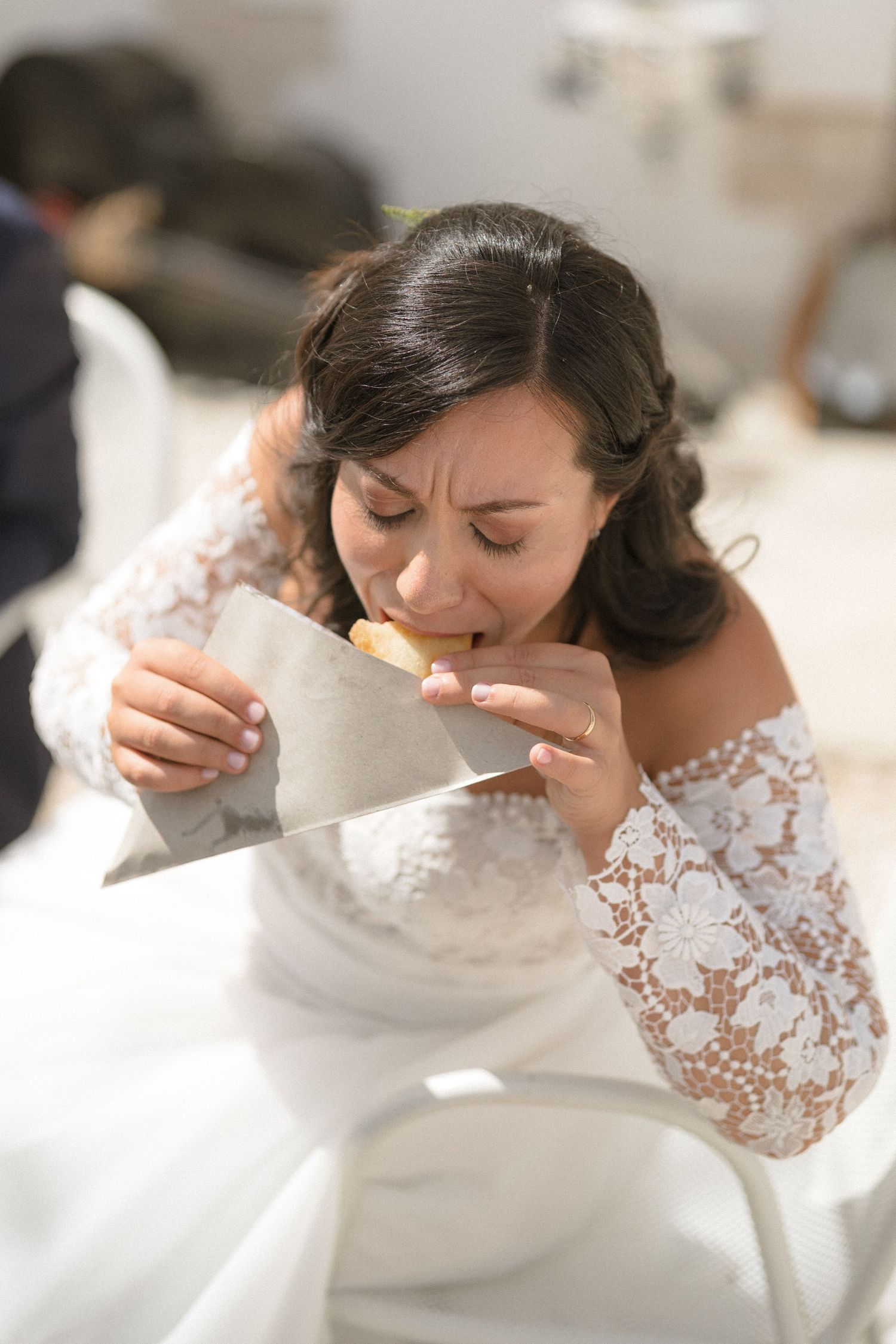A bride in a delicate lace wedding dress prepares for her special day.