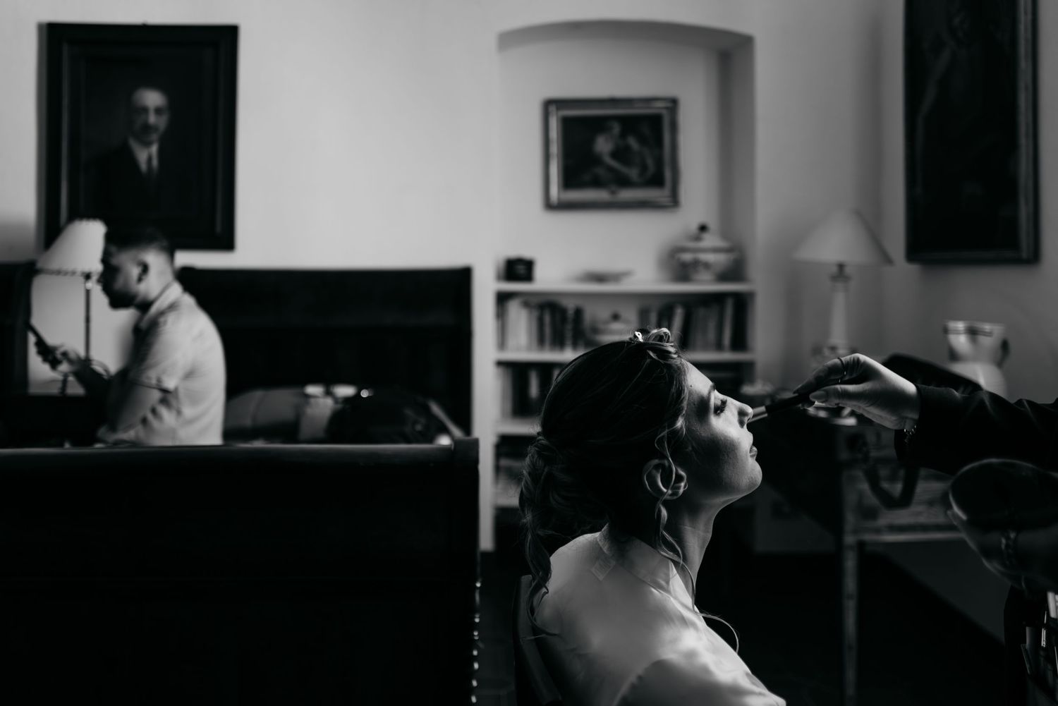 A series of black and white photographs showing a person sitting at a desk in different poses and lighting conditions.