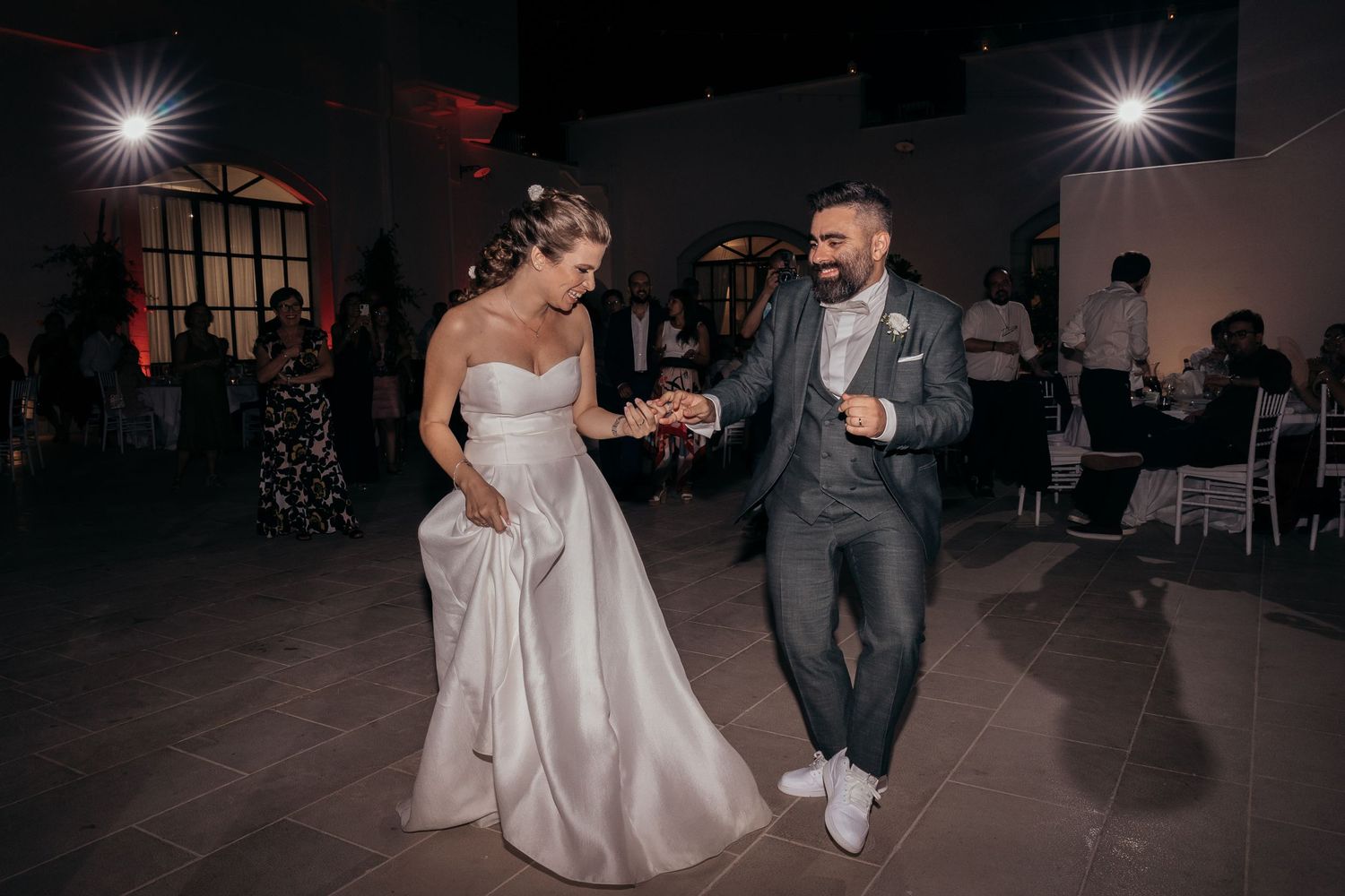 Couple dancing and celebrating at their wedding reception in an elegant venue.