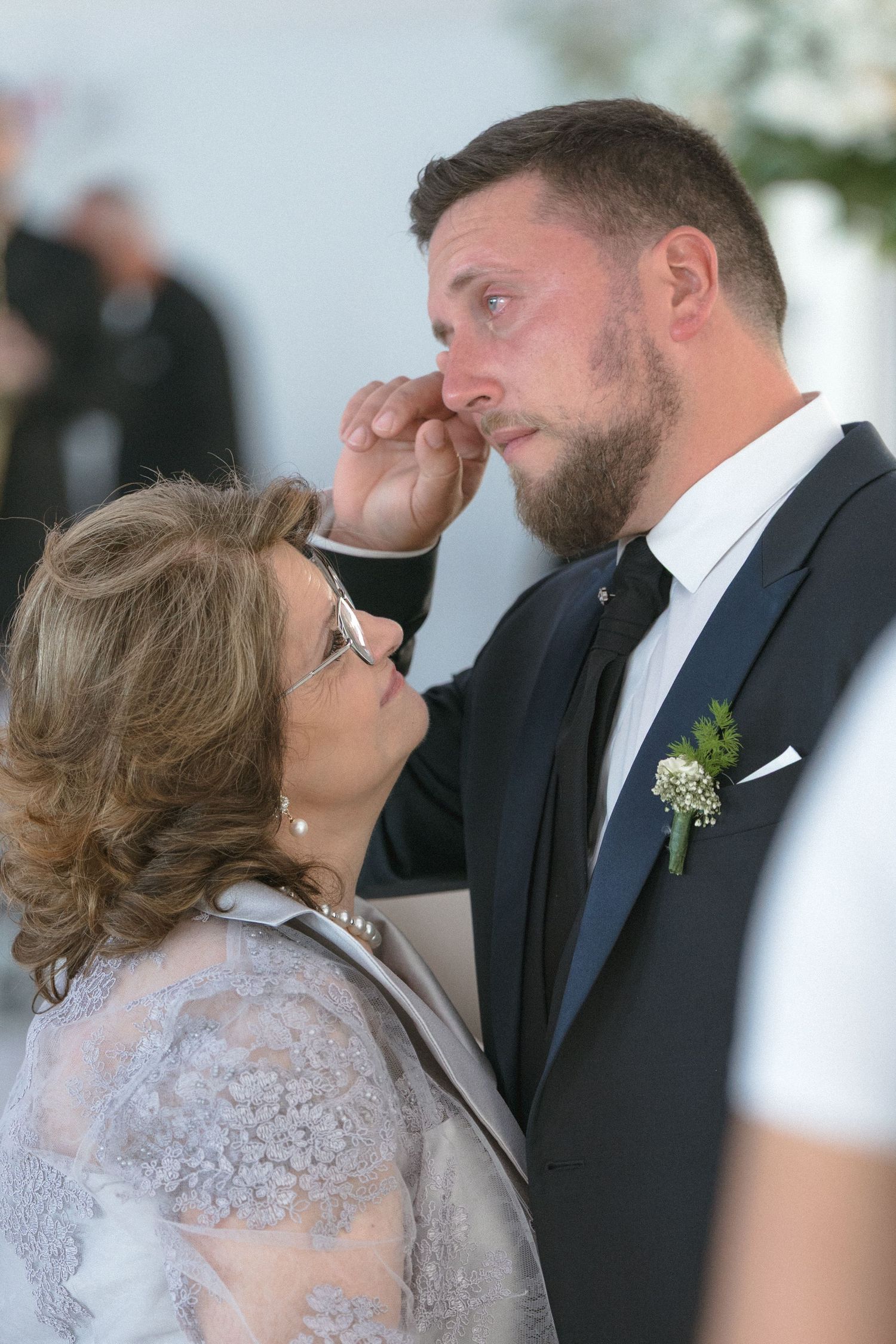 Wedding party members sharing an emotional moment during the ceremony.