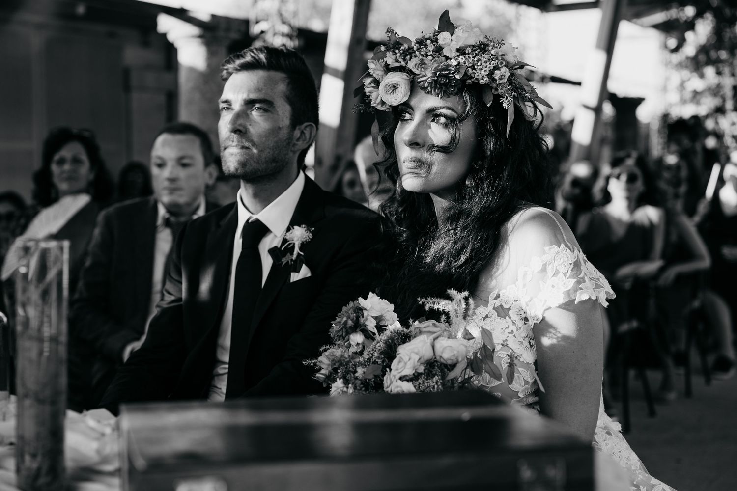 Black and white portrait of newlyweds during their wedding ceremony.