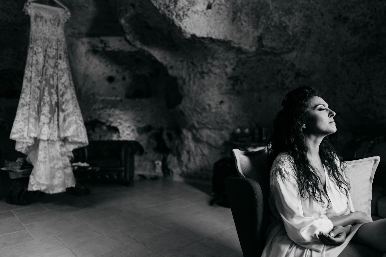 Dramatic black and white photos captured in a stone cave or grotto setting.