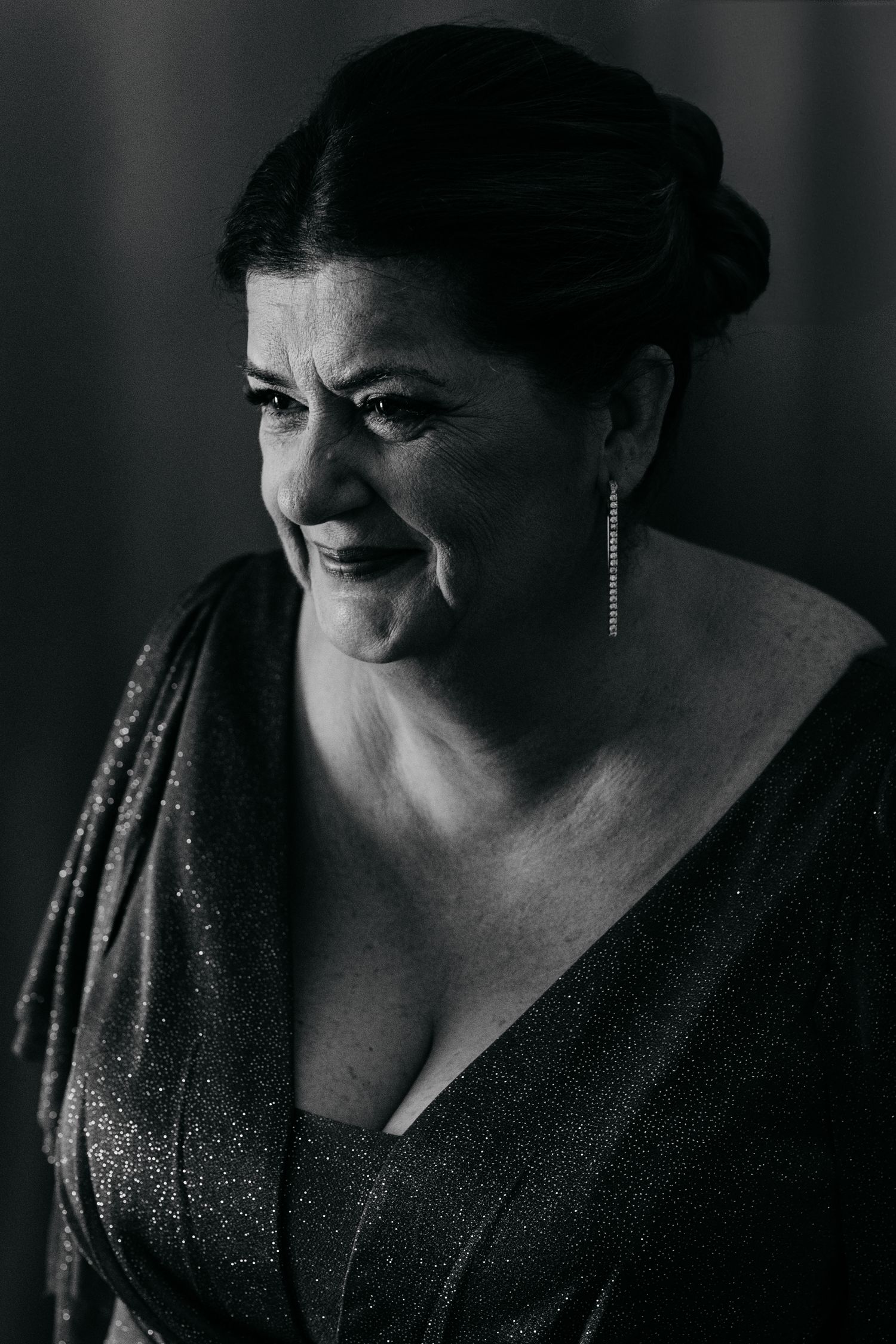 Dramatic black and white portrait in evening wear with elegant jewelry.