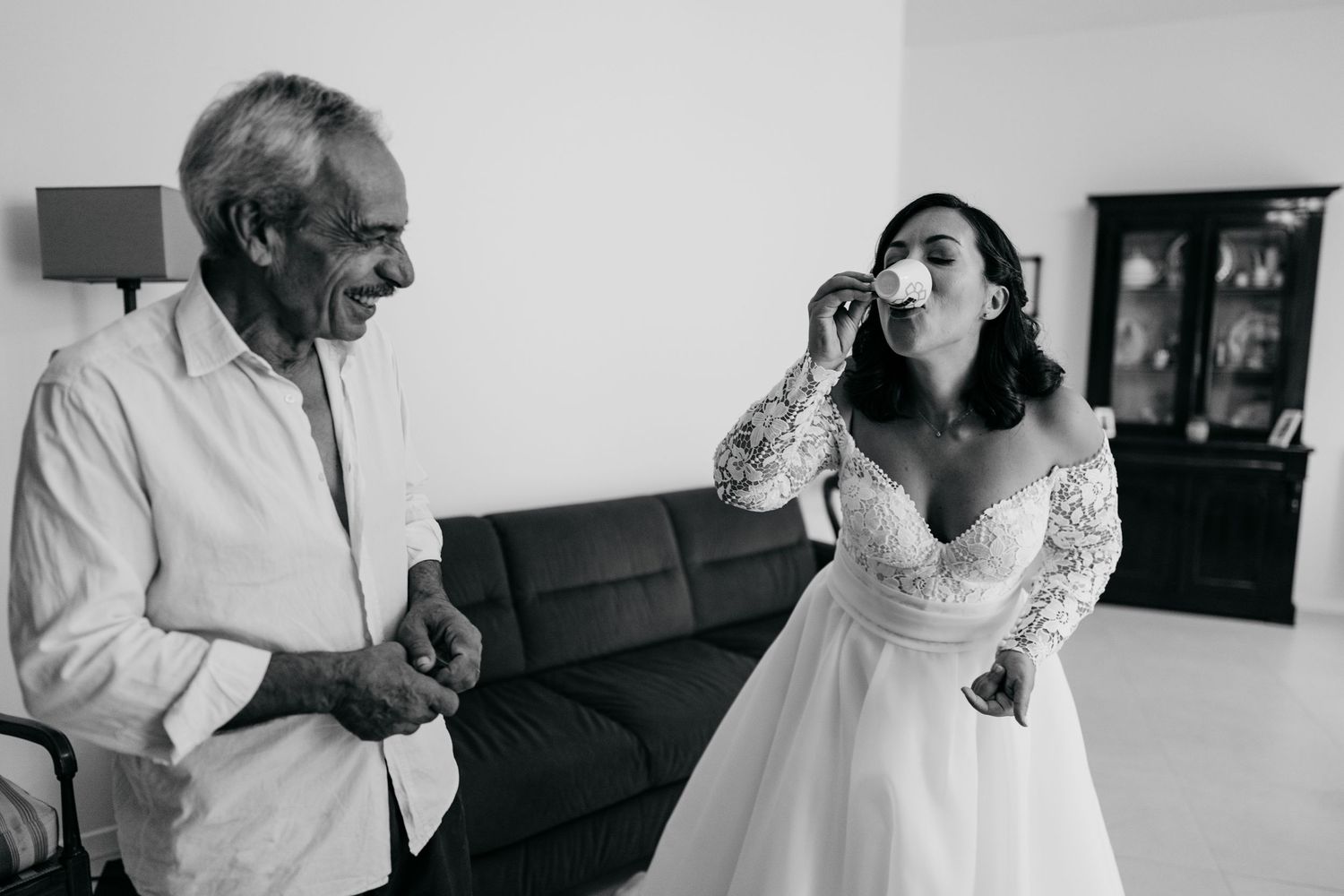 A candid black and white photo showing emotional reactions during a wedding celebration.