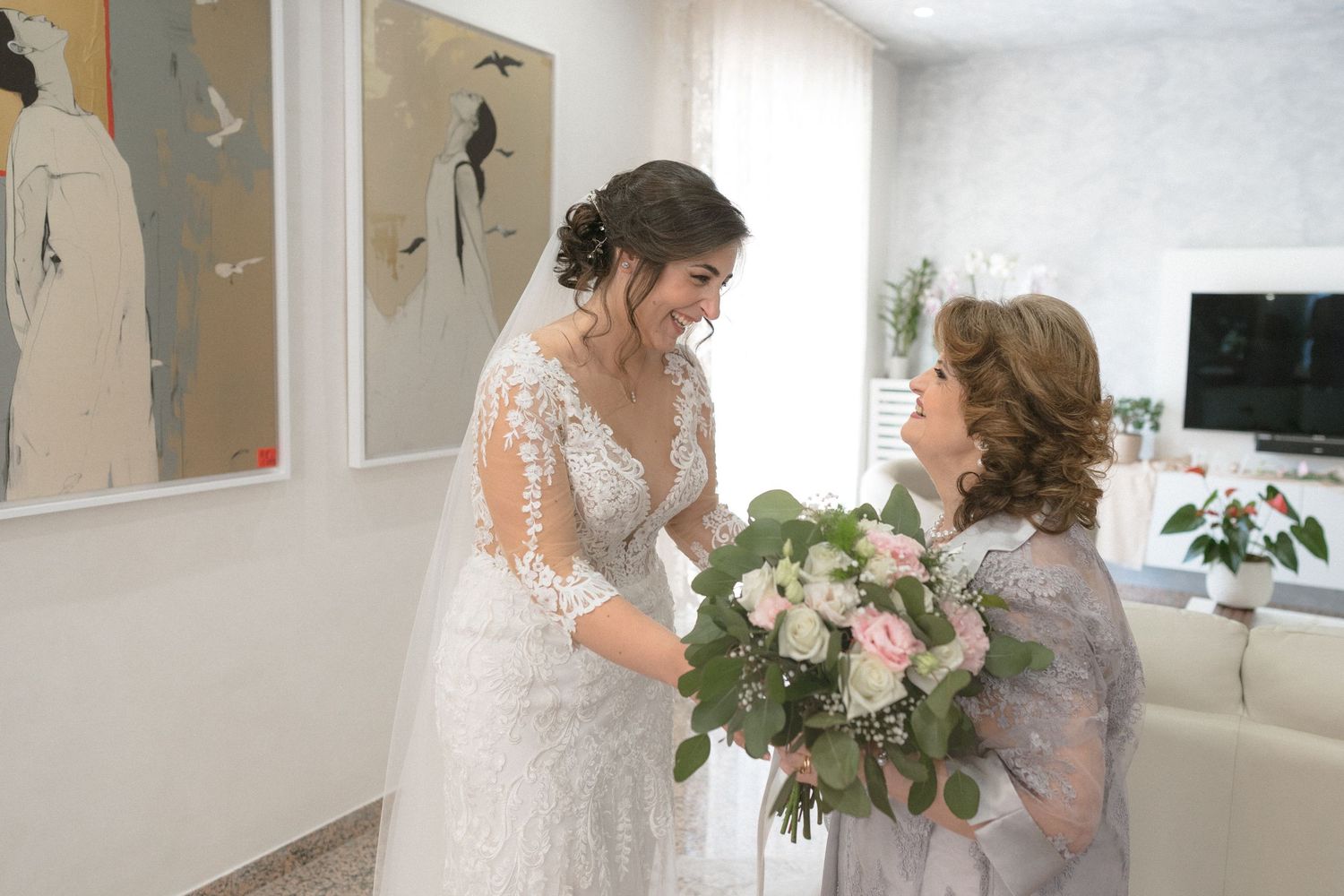 Bright indoor wedding preparation scene with natural light streaming through windows.